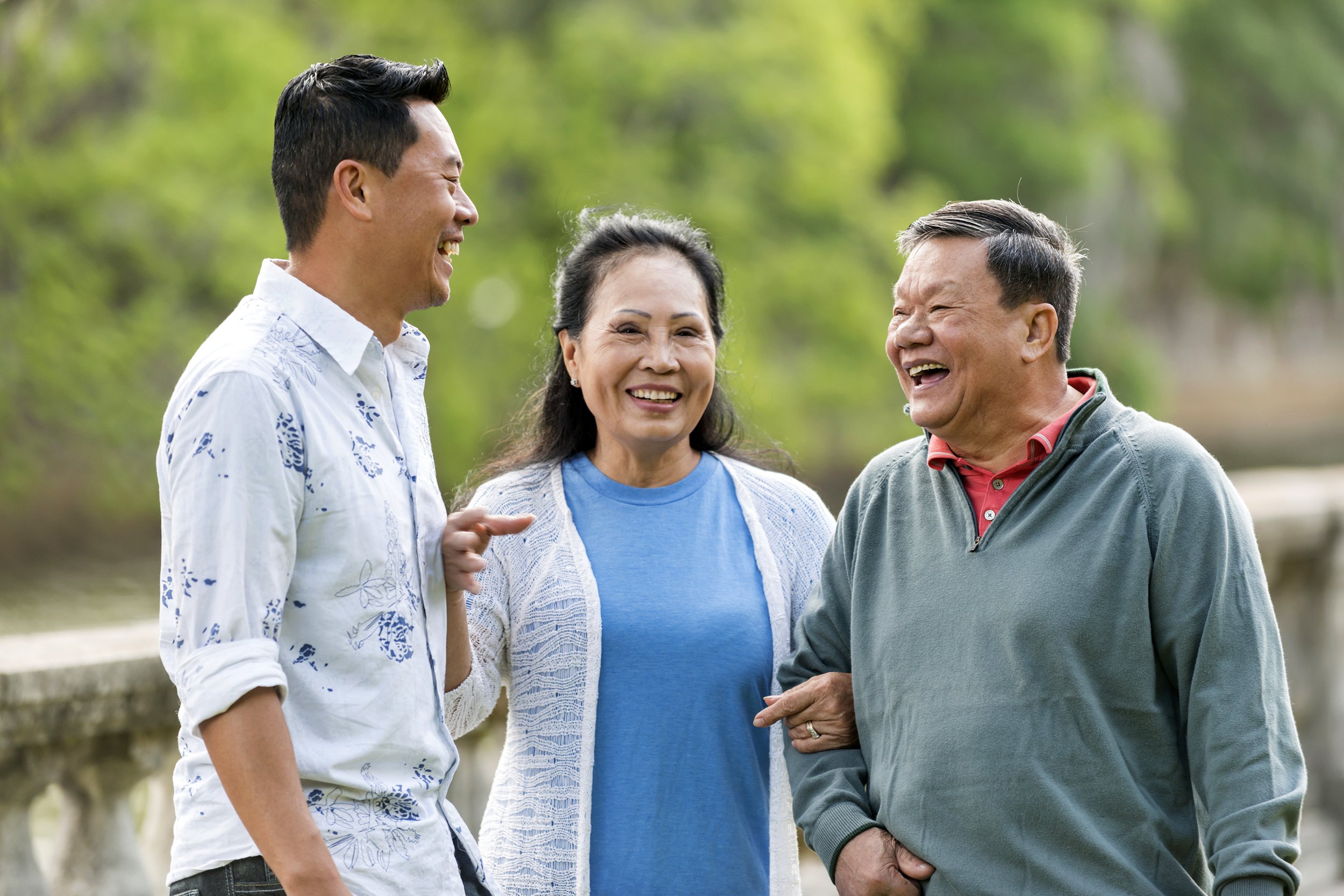 Senior Asian couple with their son smiling