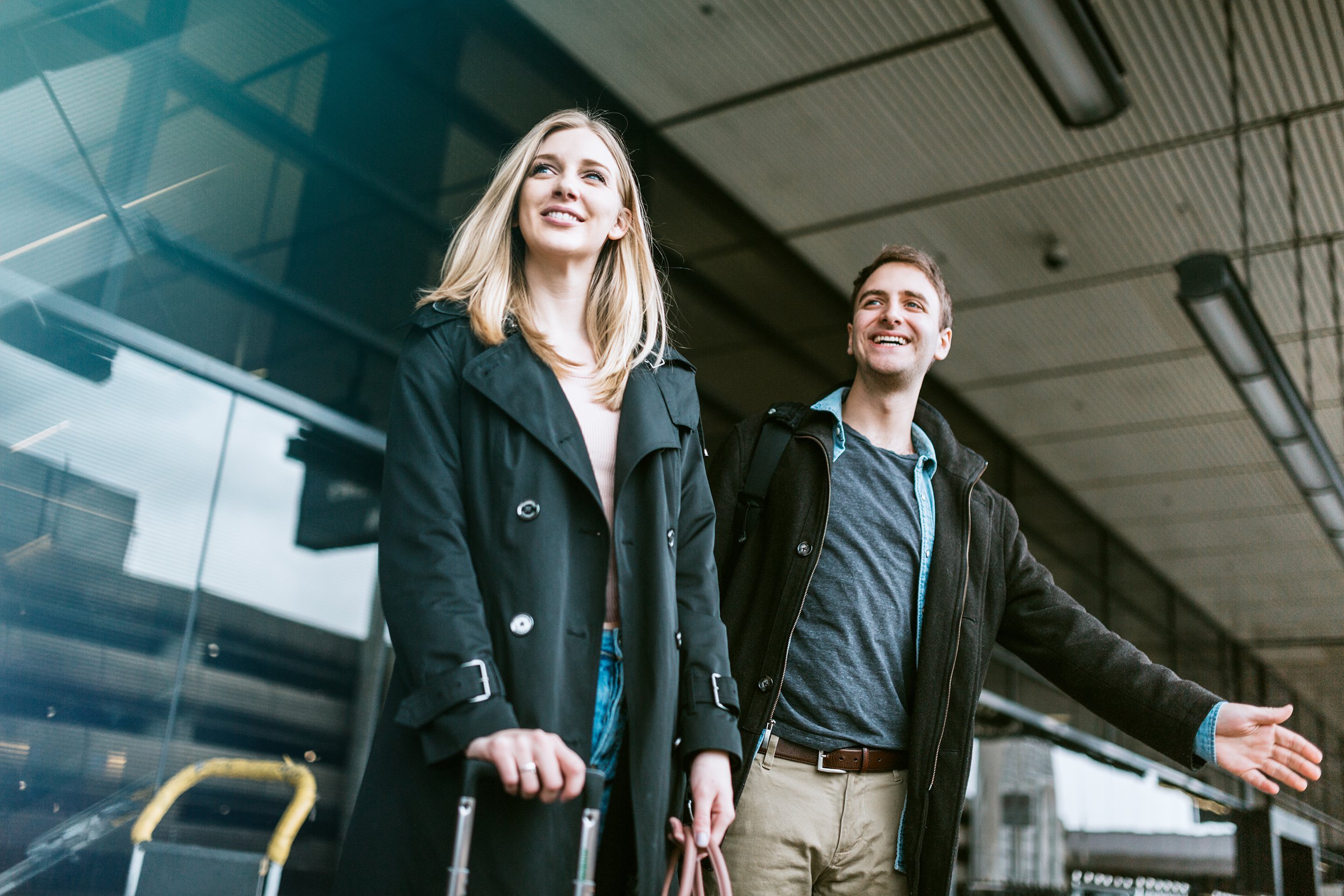 couple wait for ride at airport