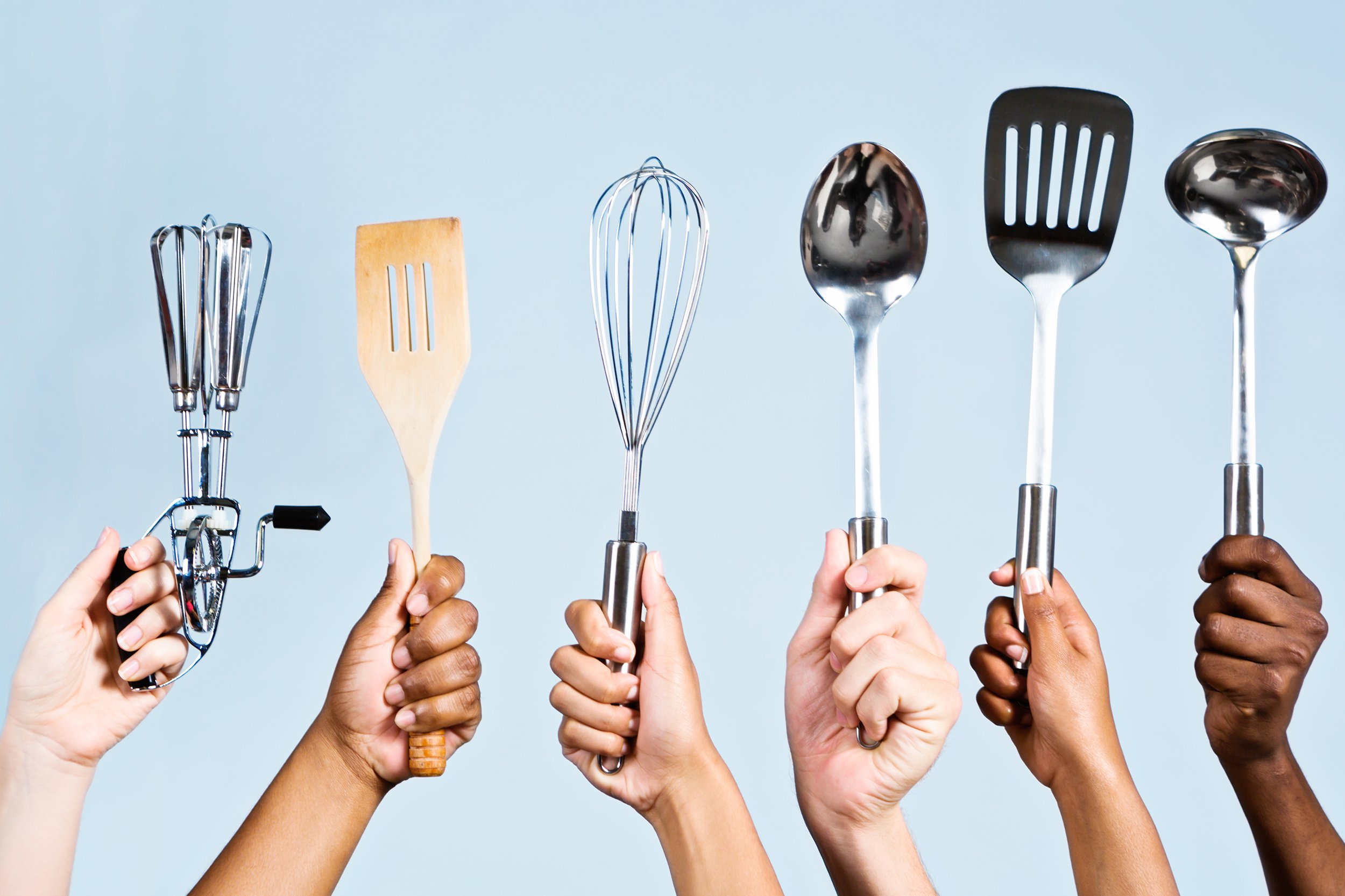 six mixed hands holding kitchen utensils