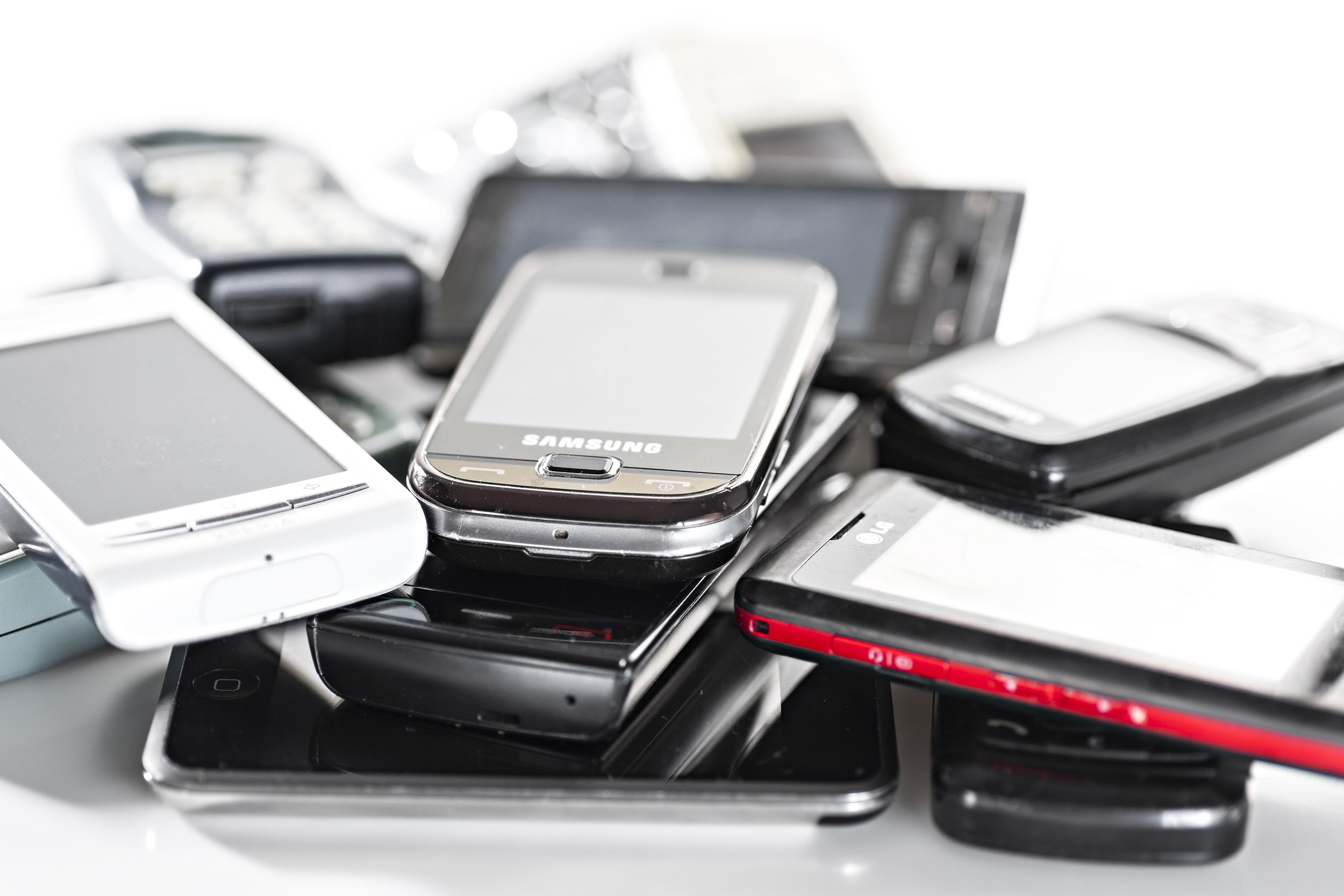 pile of old cellphones