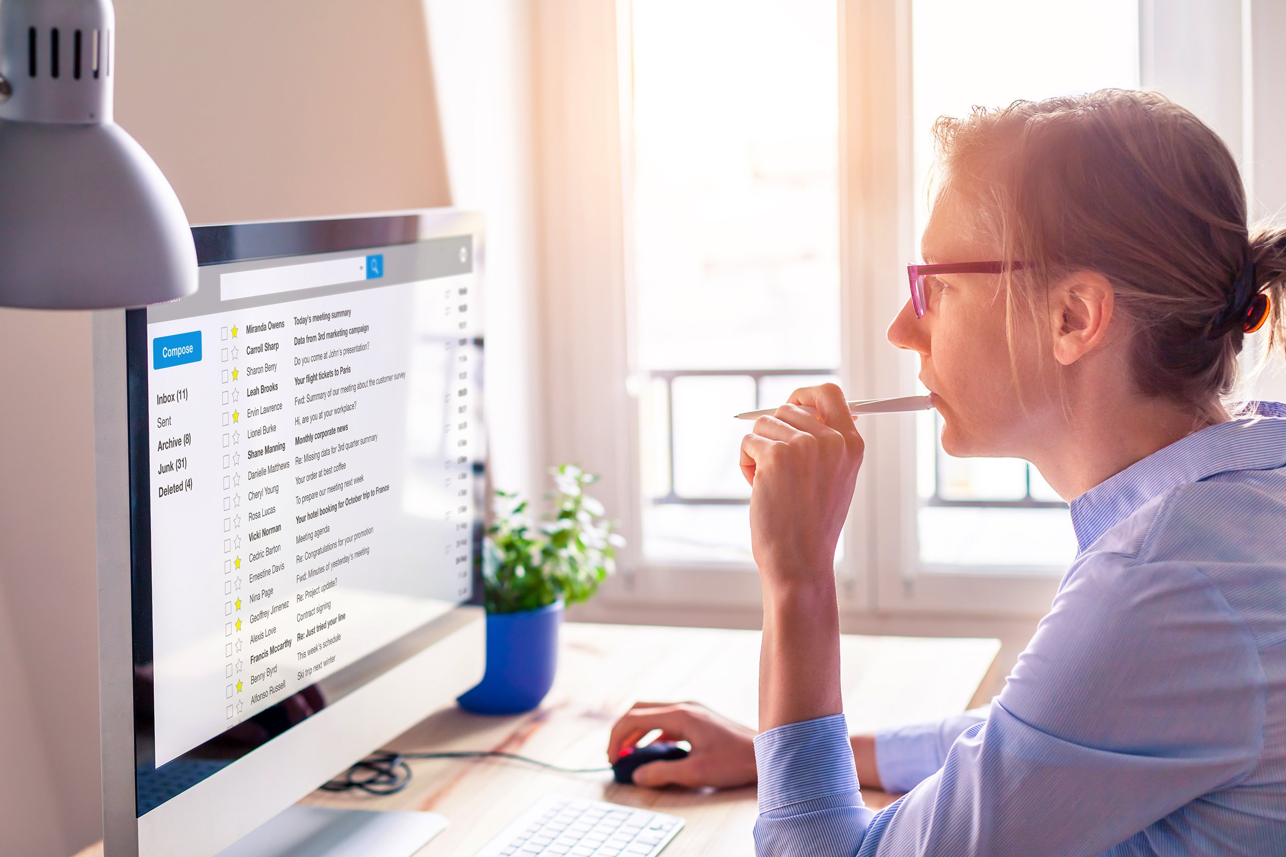 woman on desktop computer looking at email inbox