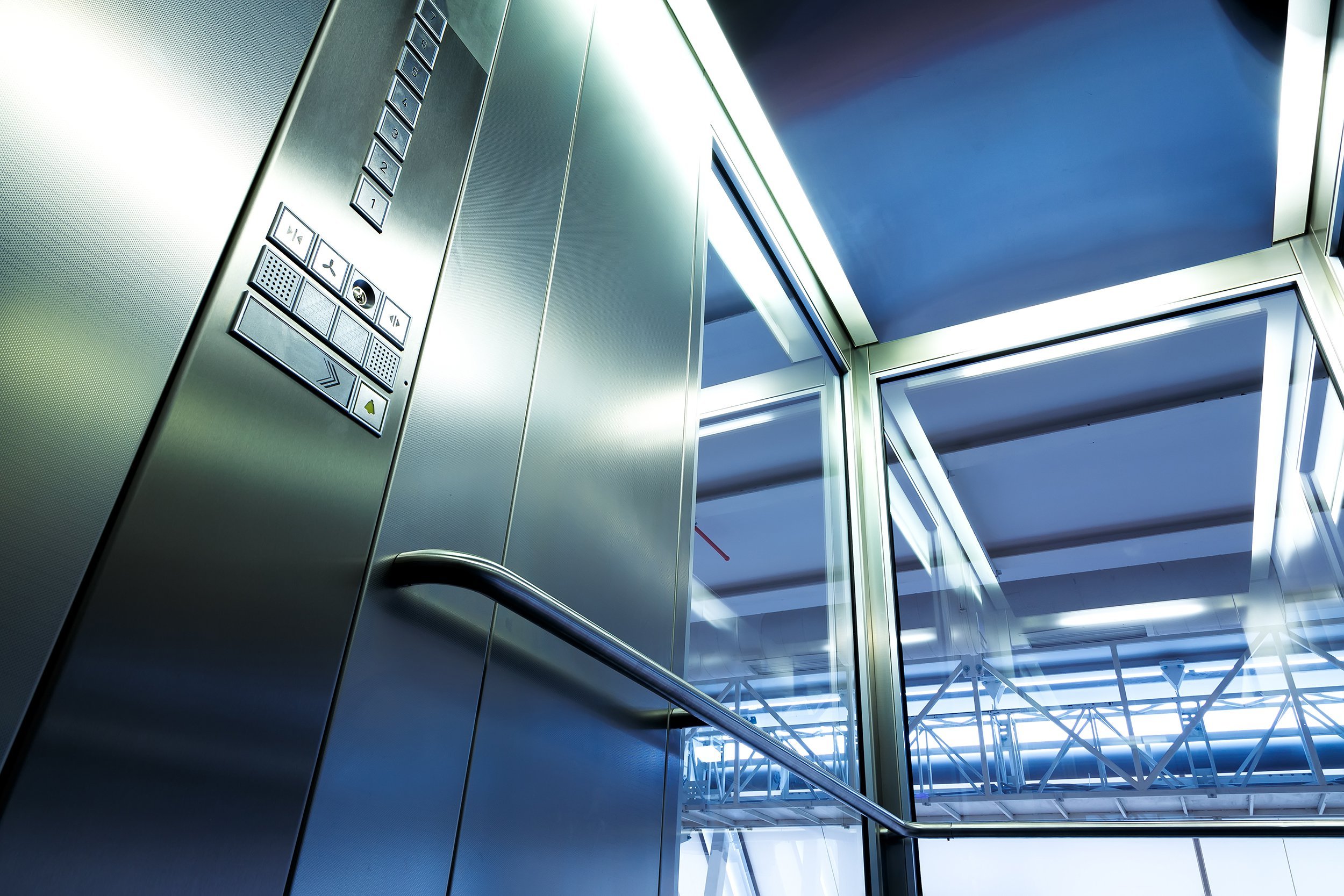 business people riding elevator and showing thumbs-up