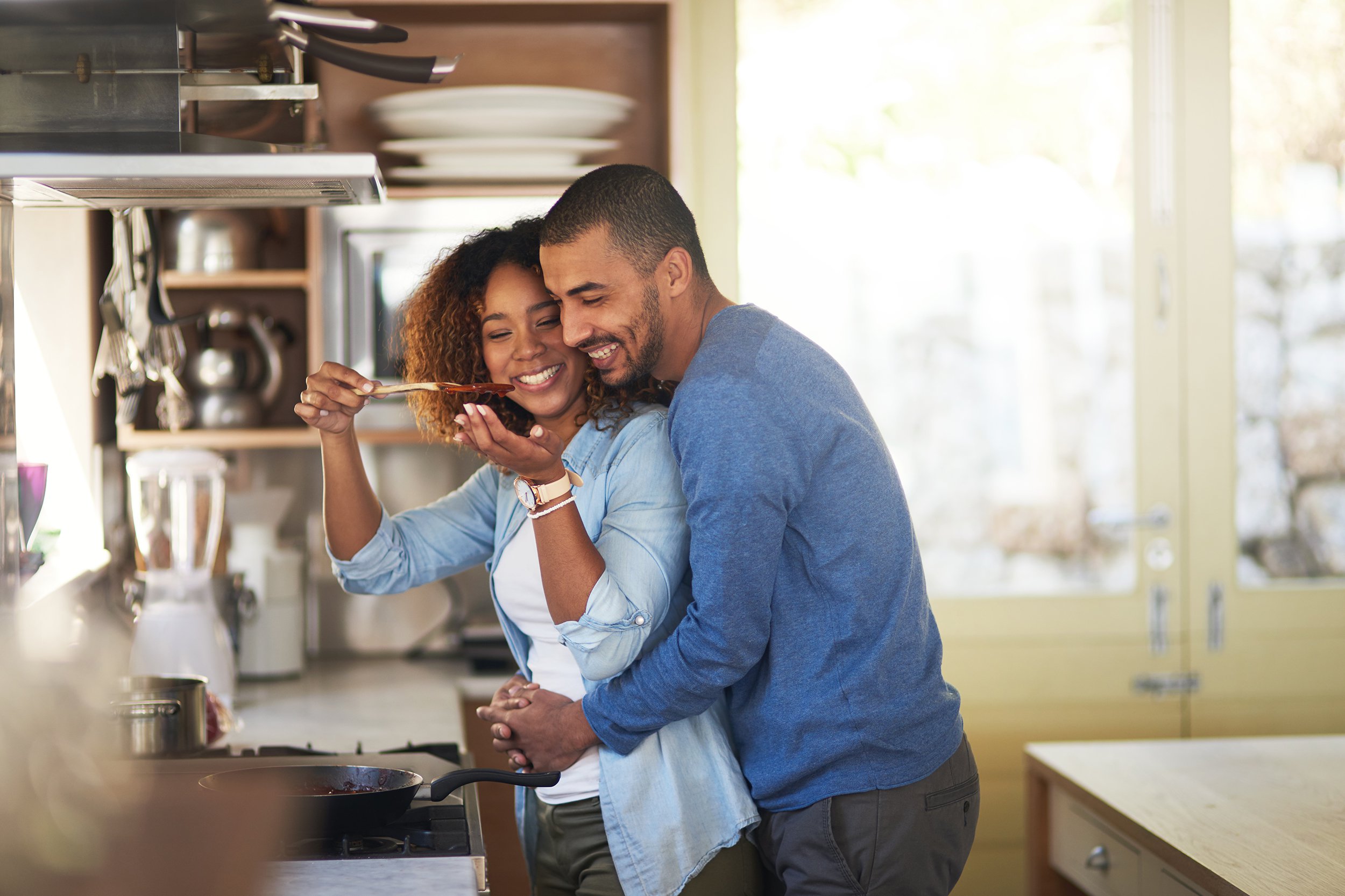 African American couple cooking dinner at home
