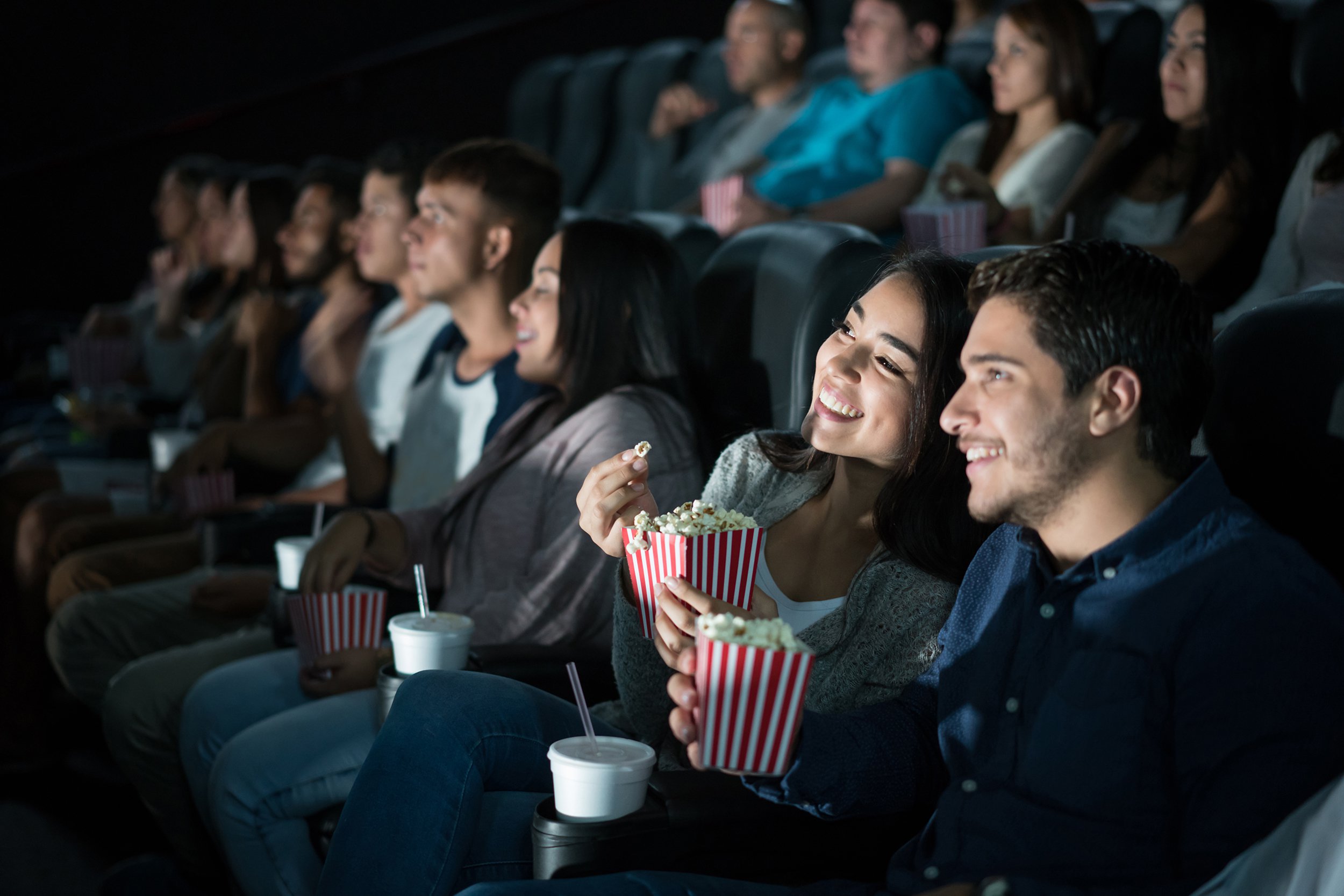 happy Hispanic couple at the movies