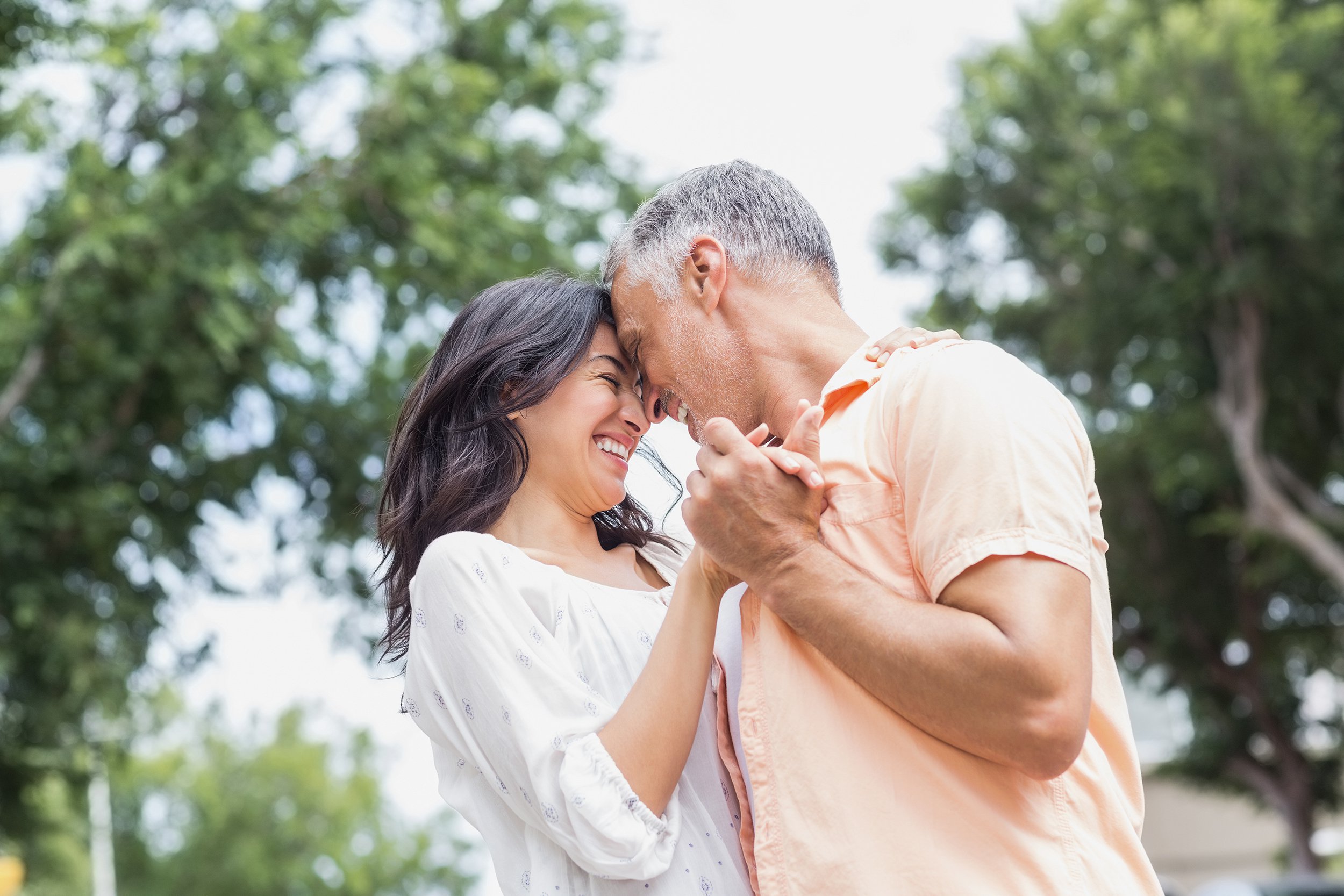 middle-aged couple dancing outside