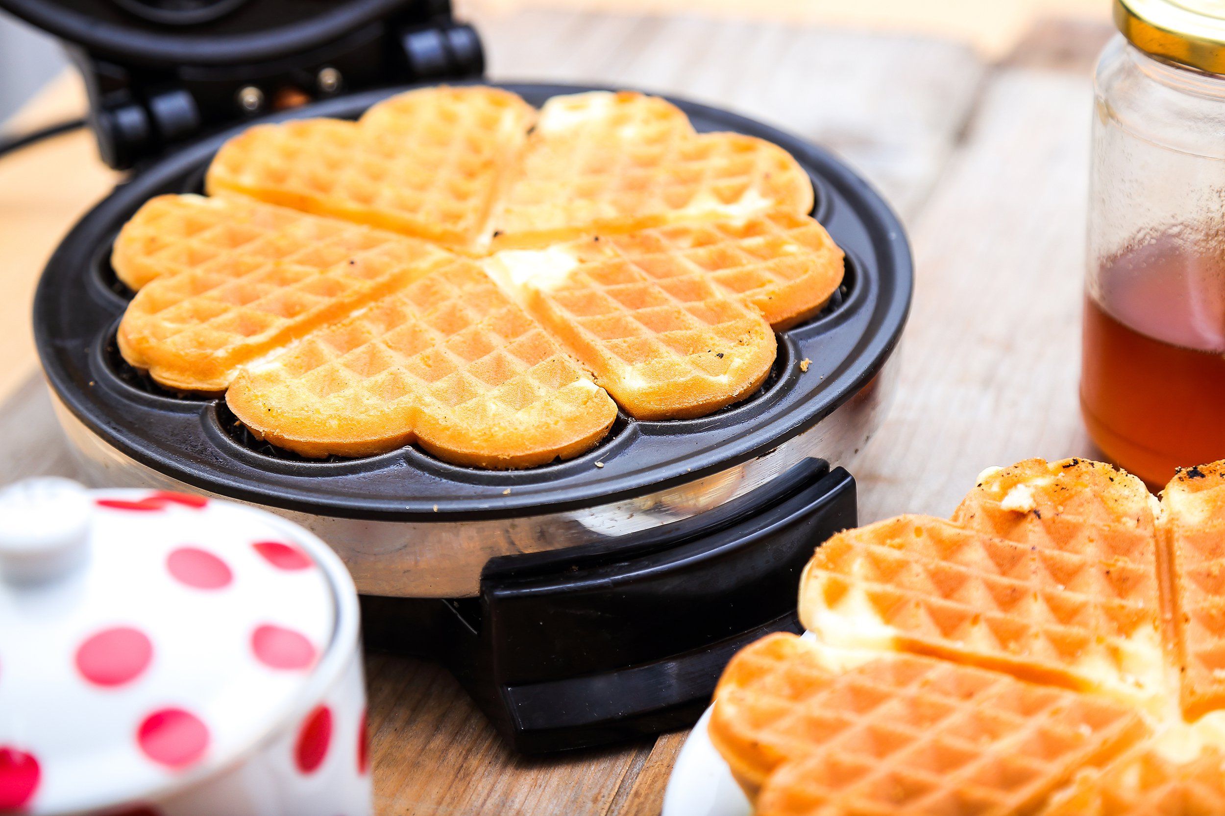 heart waffles being made in maker