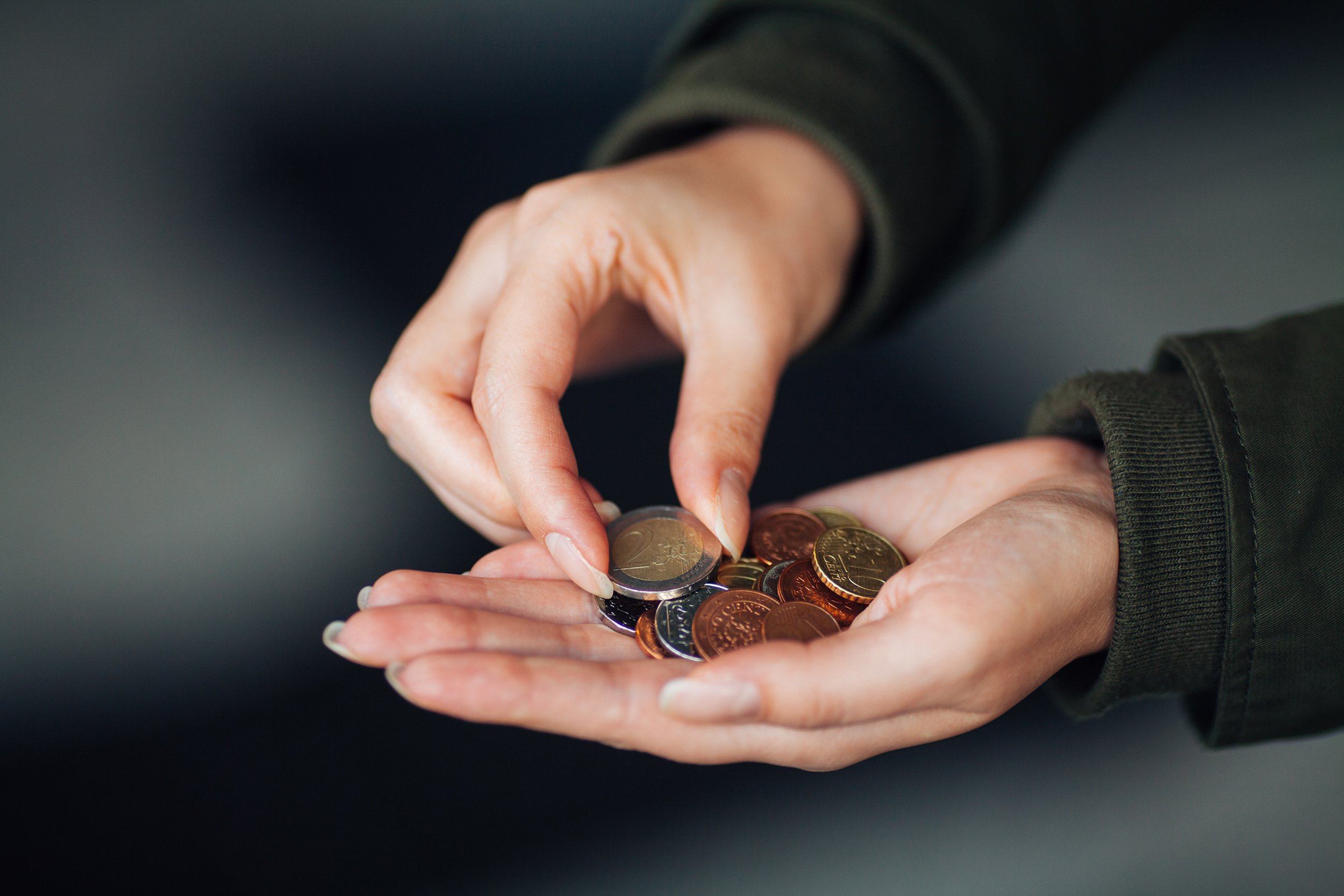 Euro coins in female hand