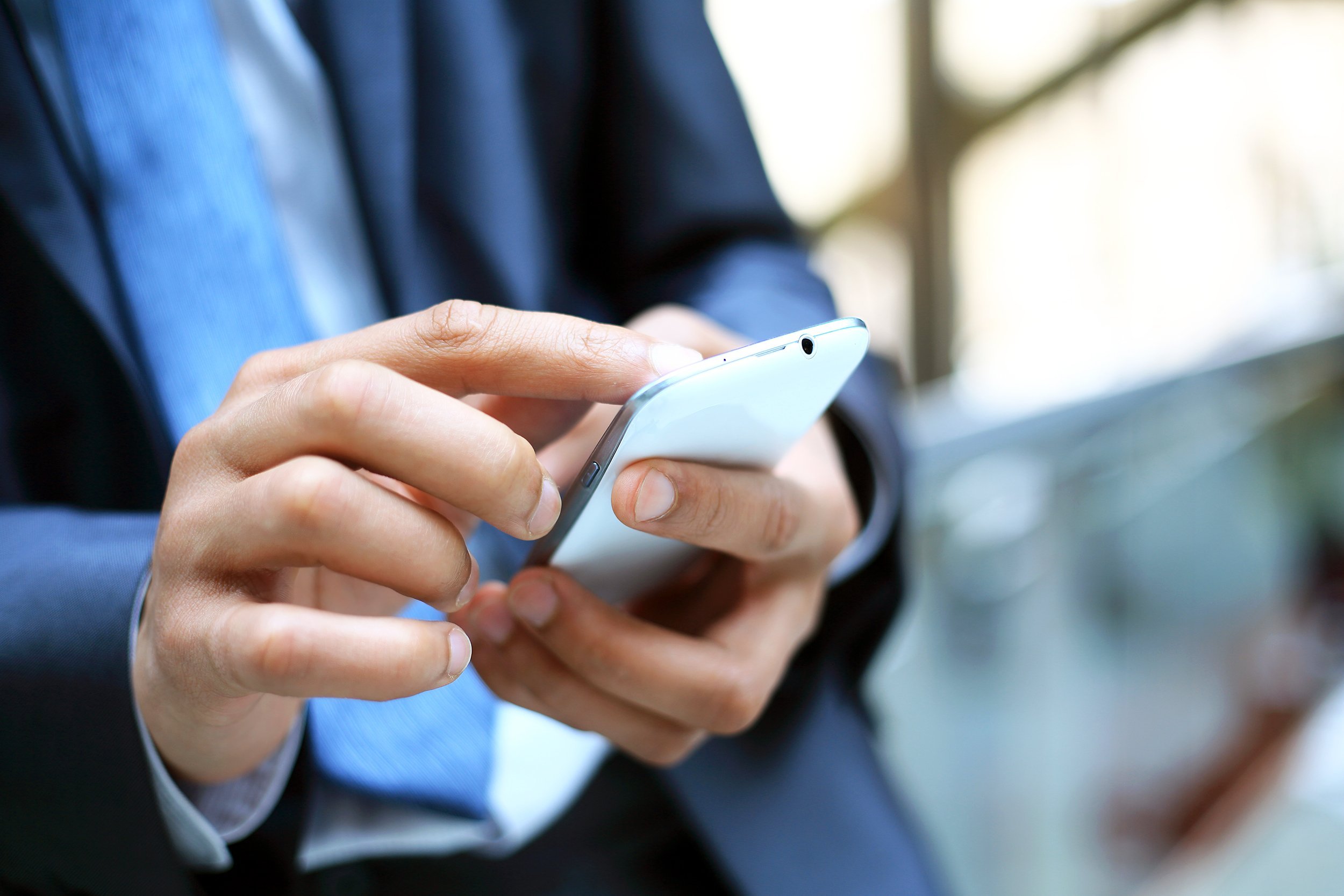 close up of a man using mobile smart phone
