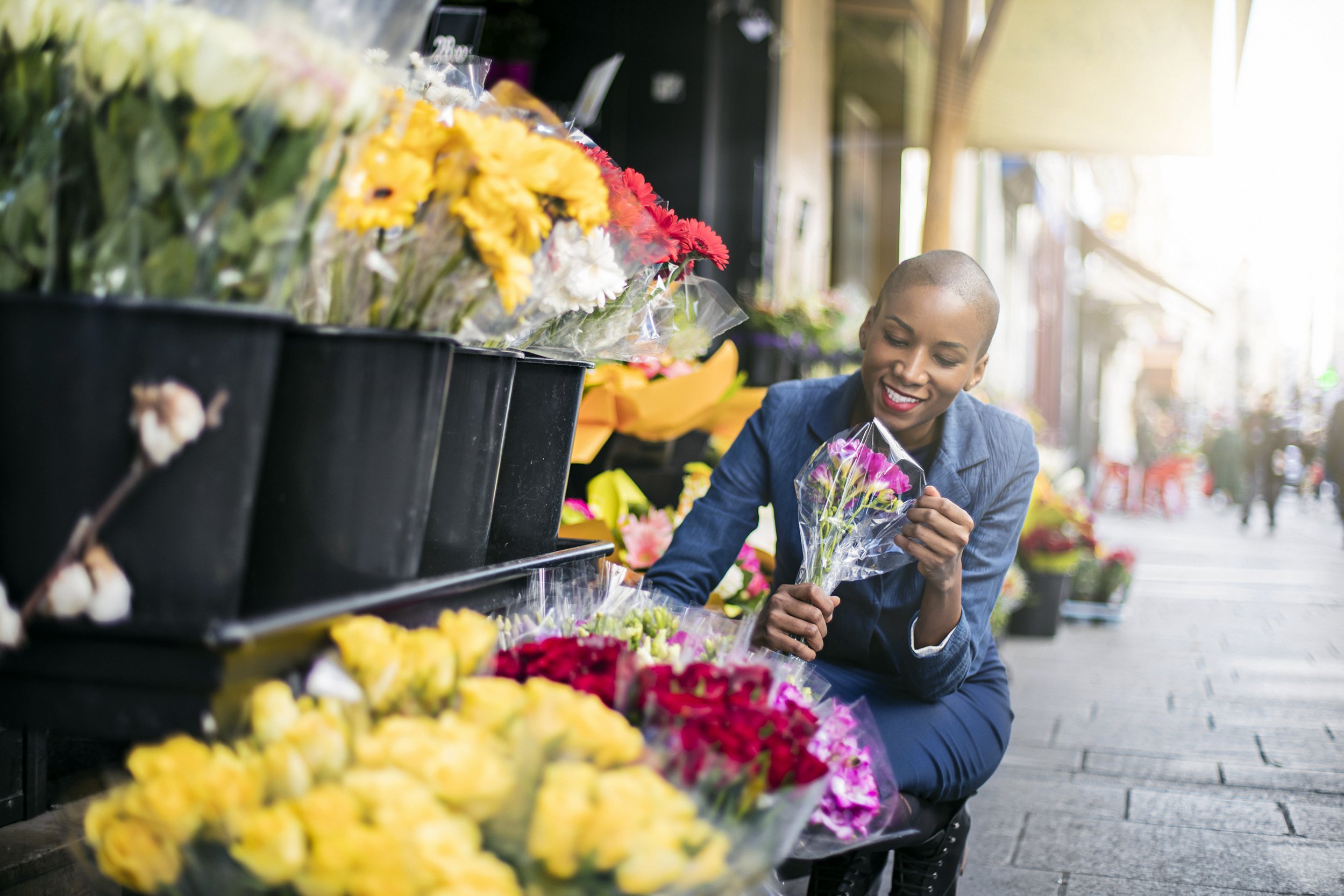 Woman buying flowers from a local shop