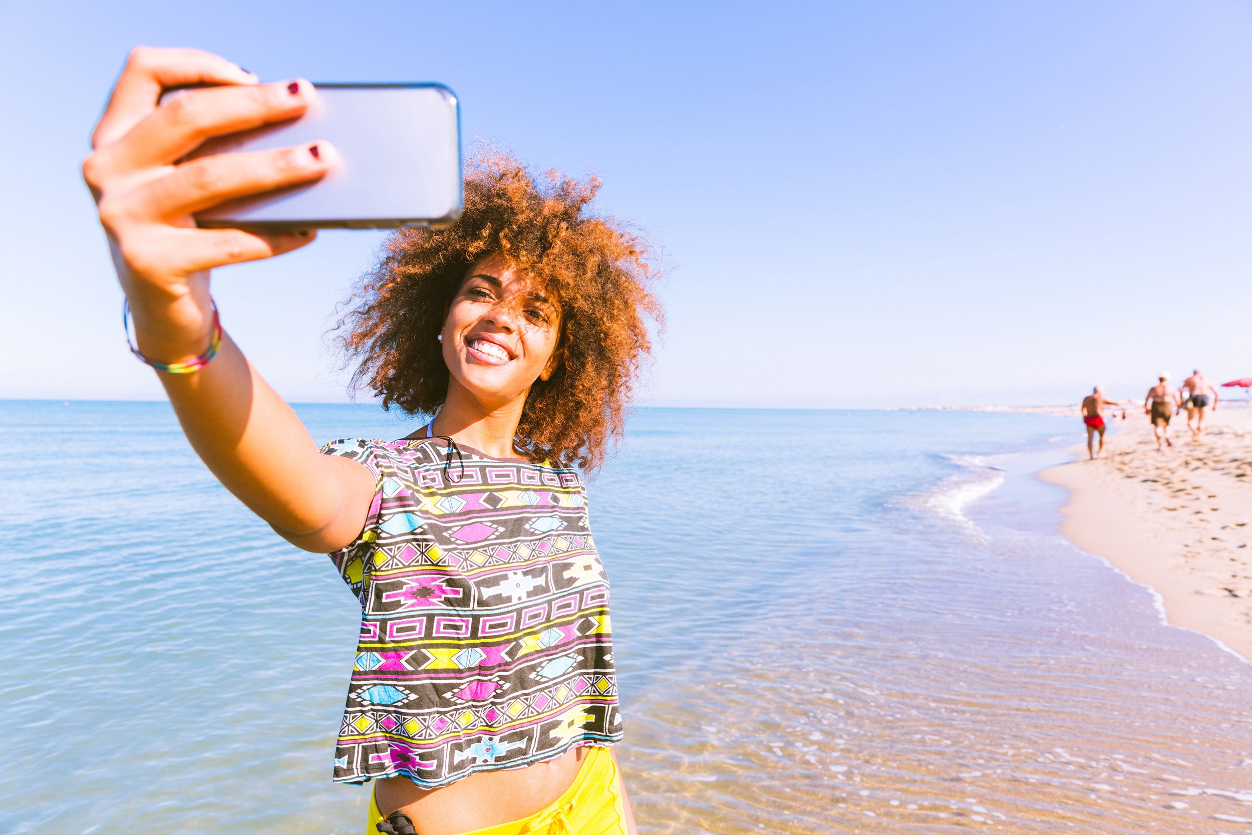 Woman taking selfie on the beach