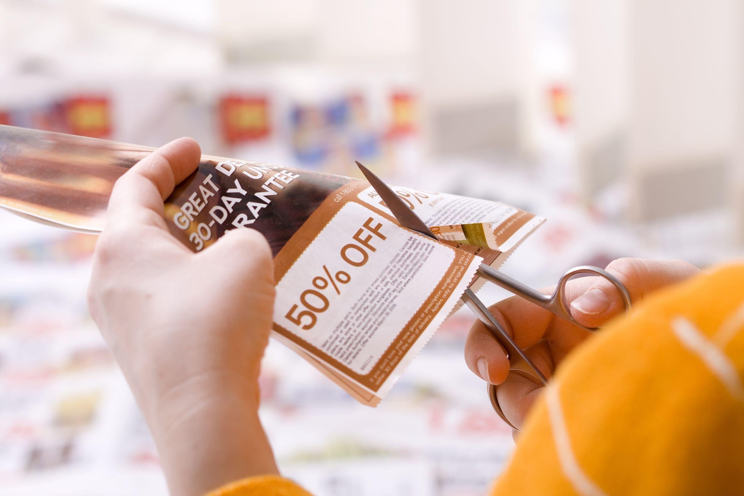 woman cutting coupon