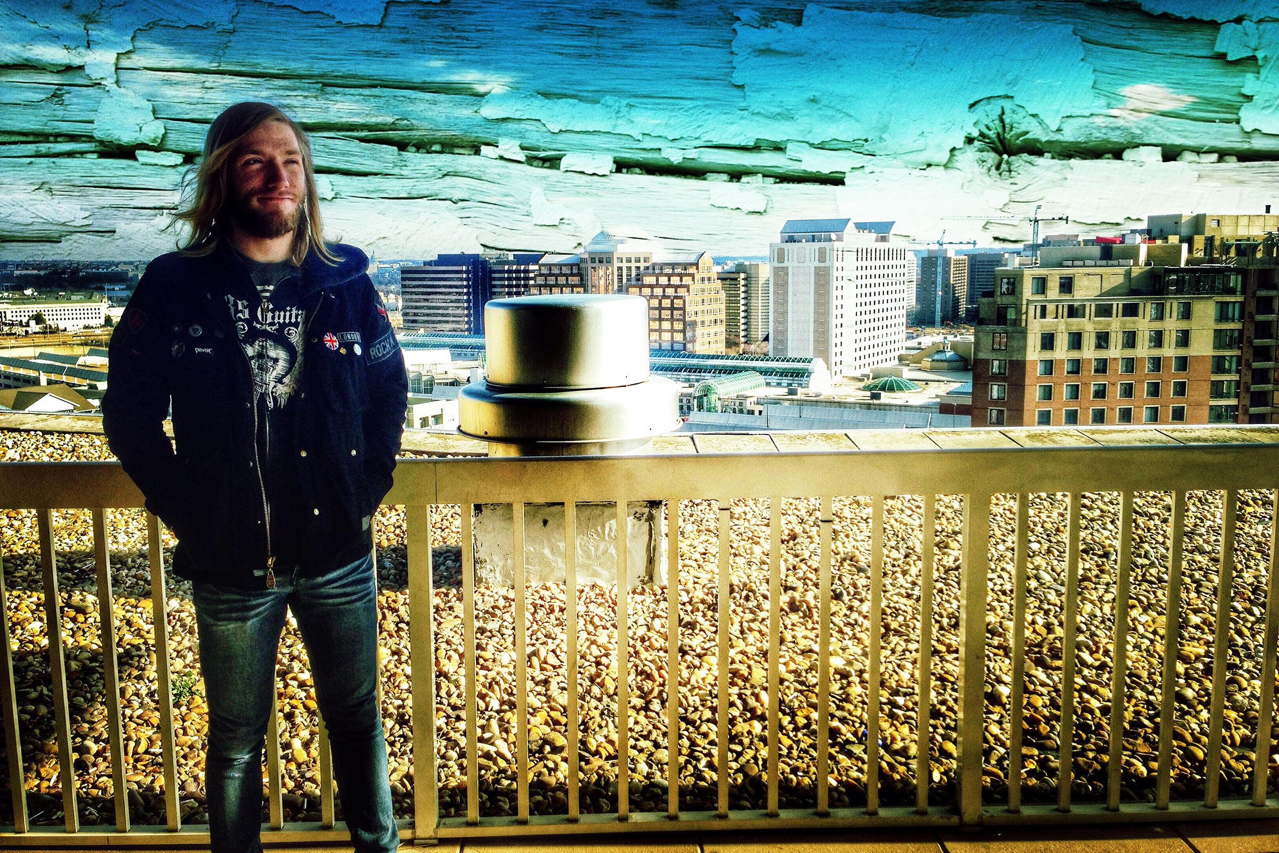 Photo of man standing on a bridge using Snapseed app