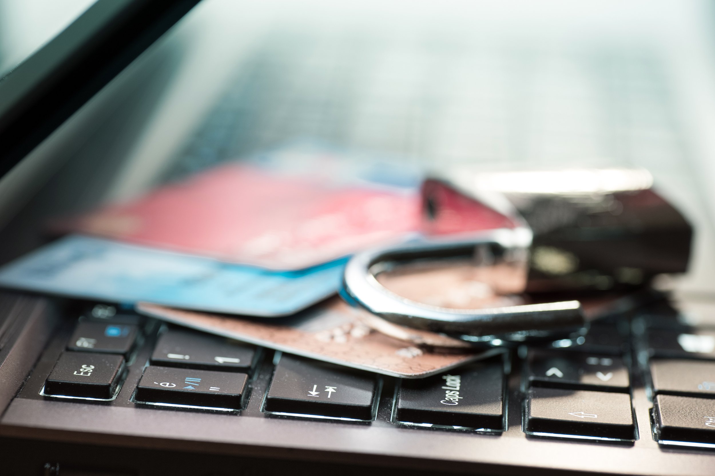 Laptop with credit cards and a broken lock
