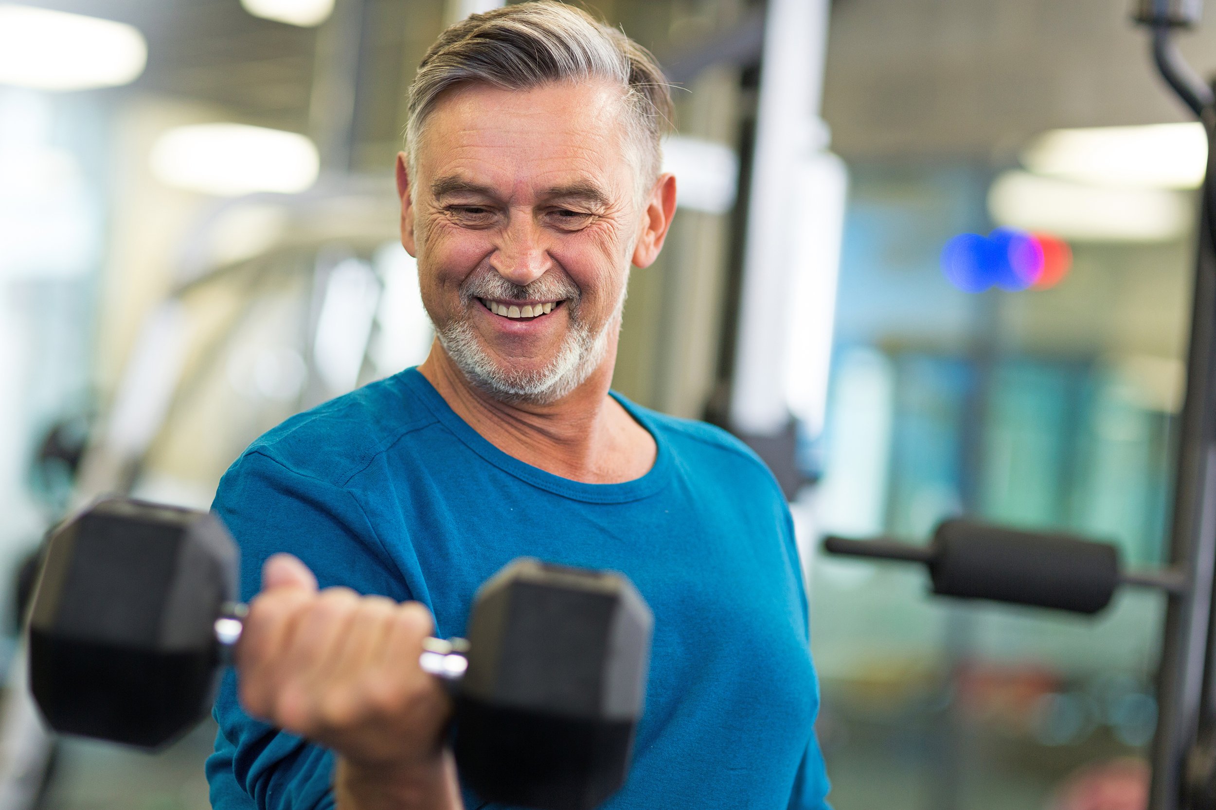 Senior man lifting free weights