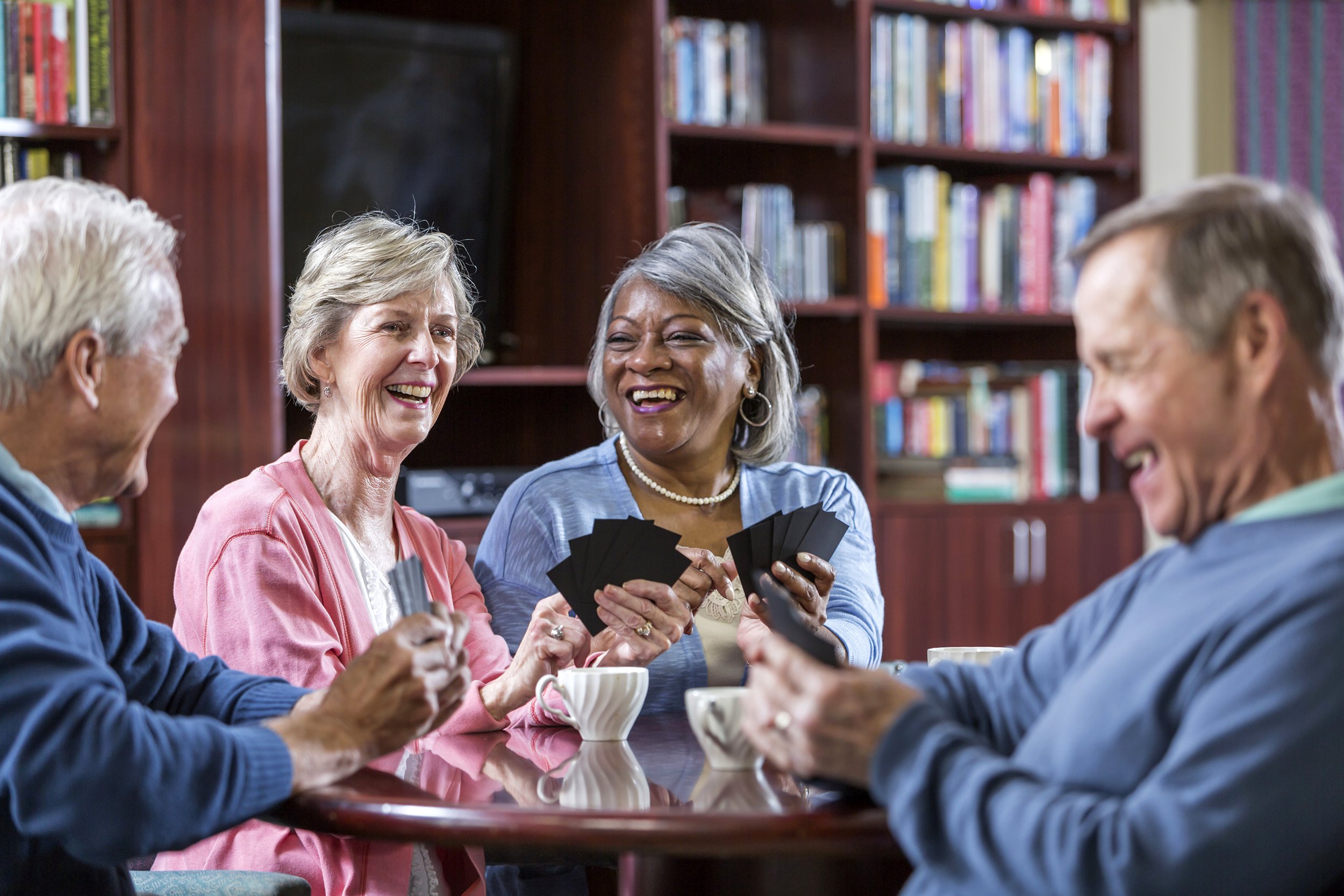 Senior friends playing cards