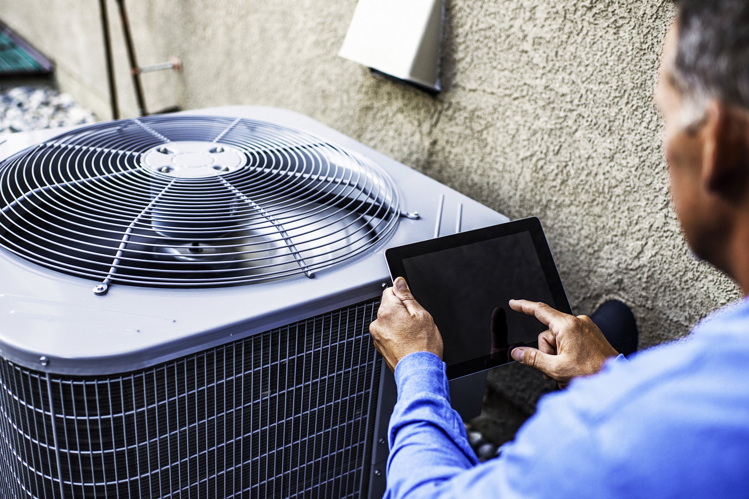 Man inspecting an AC unit