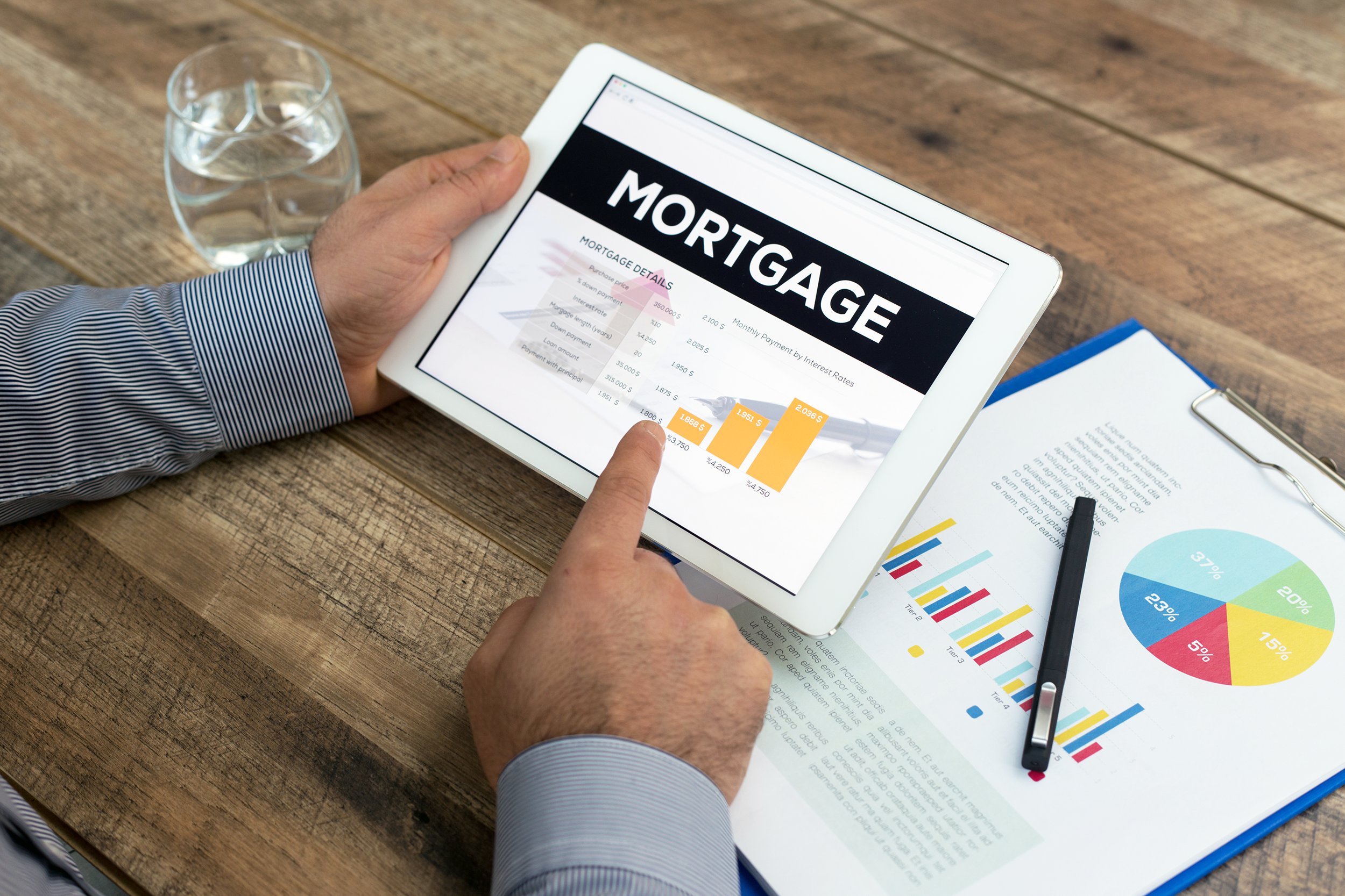 Person researching mortgage loans on his tablet