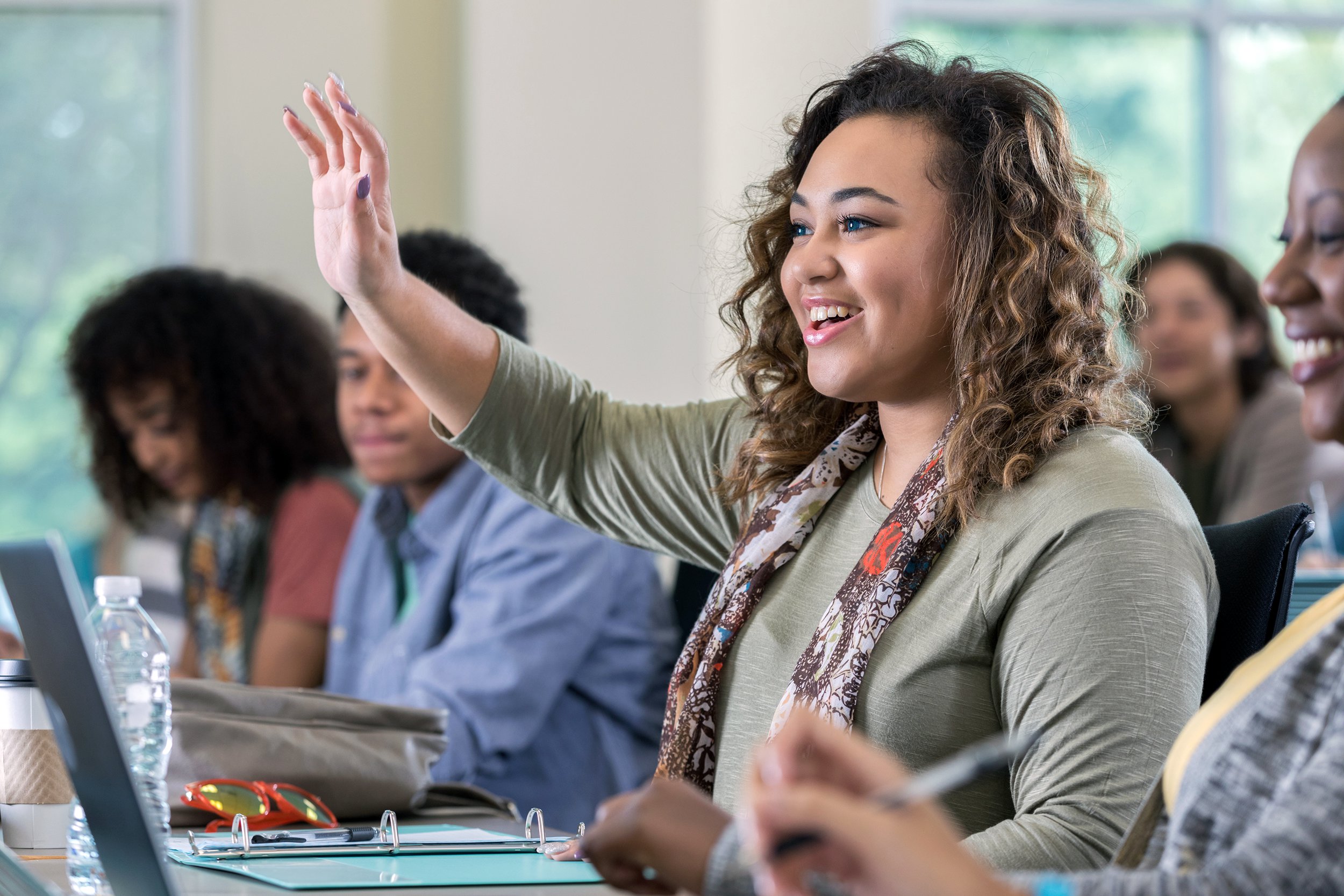 Woman raising hand in an adult class