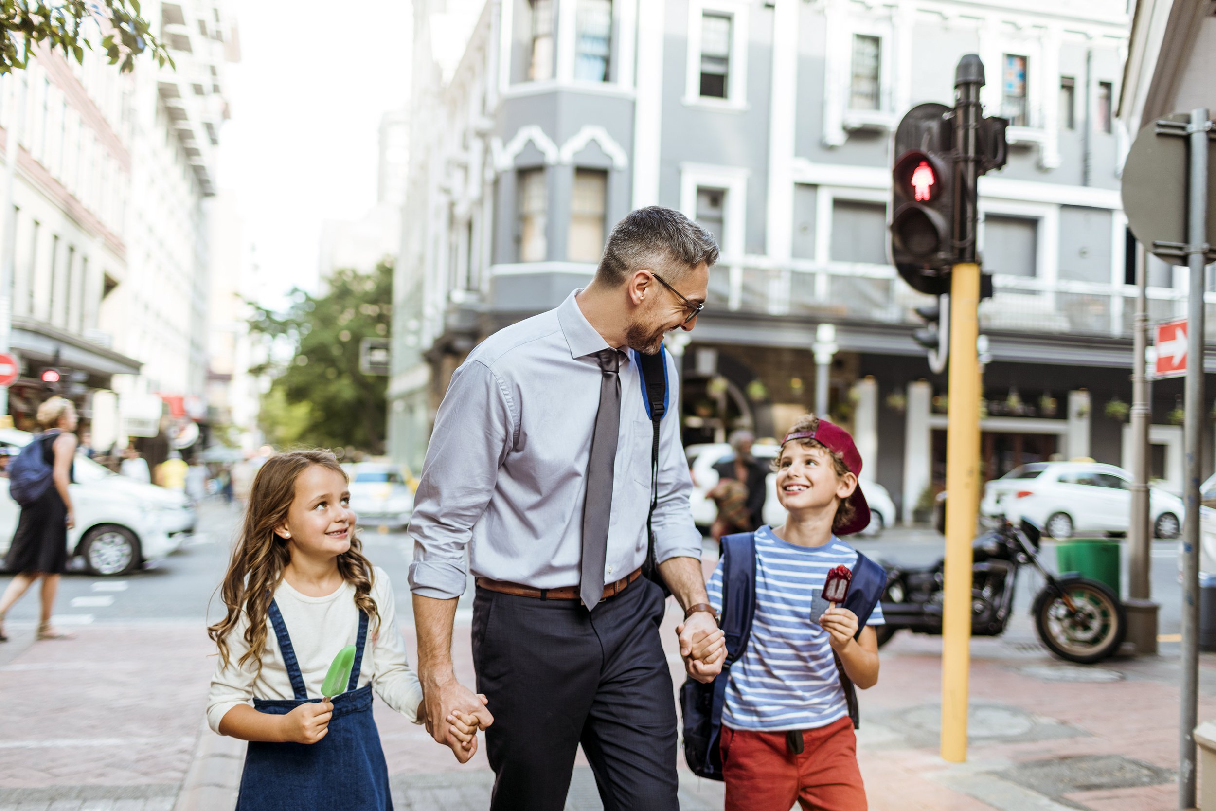 father with two kids going to school