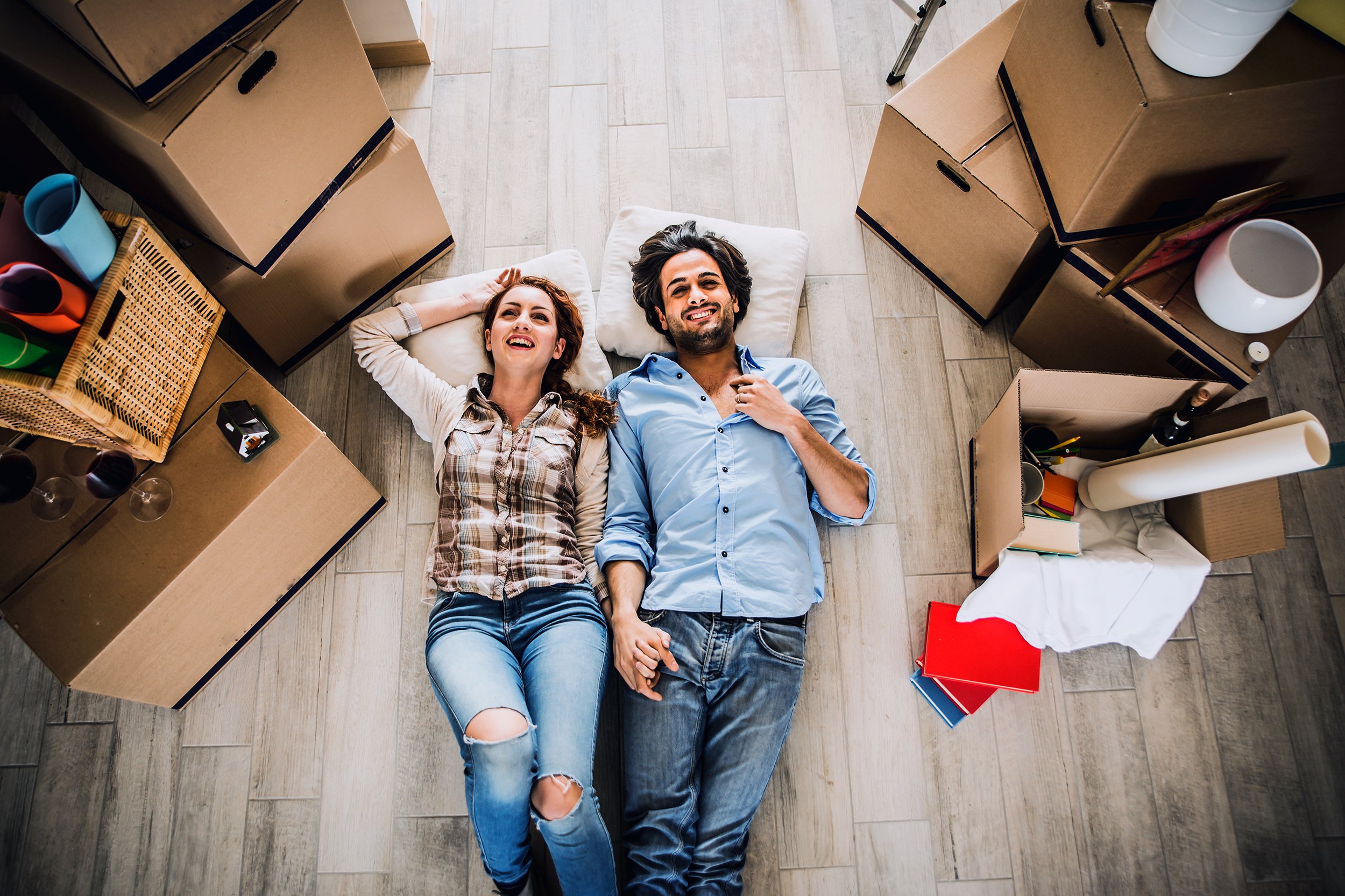 young couple moving in into new apartment