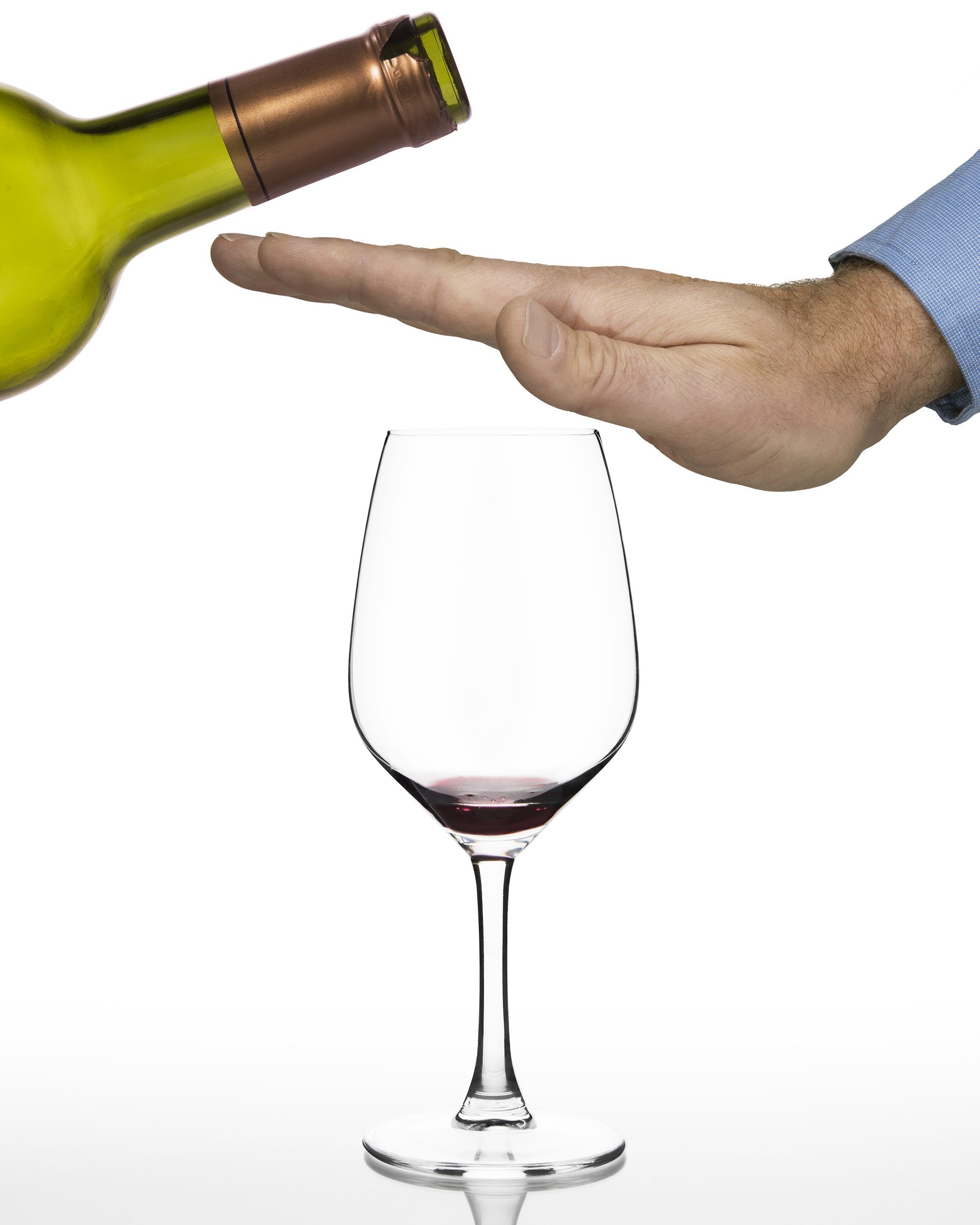 hand of a man refusing anymore red wine