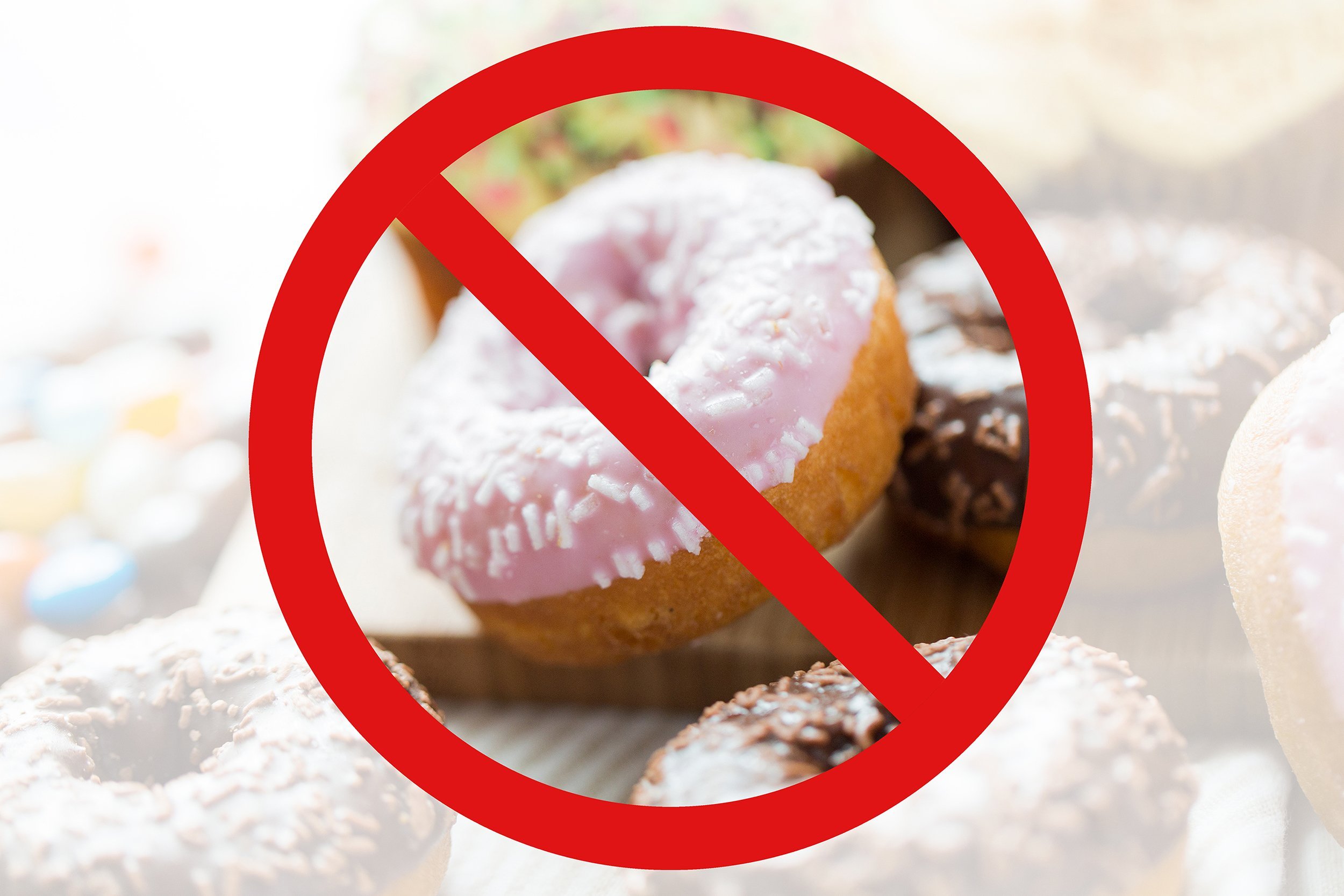 close up of glazed donuts behind no symbol or circle-backslash prohibition sign