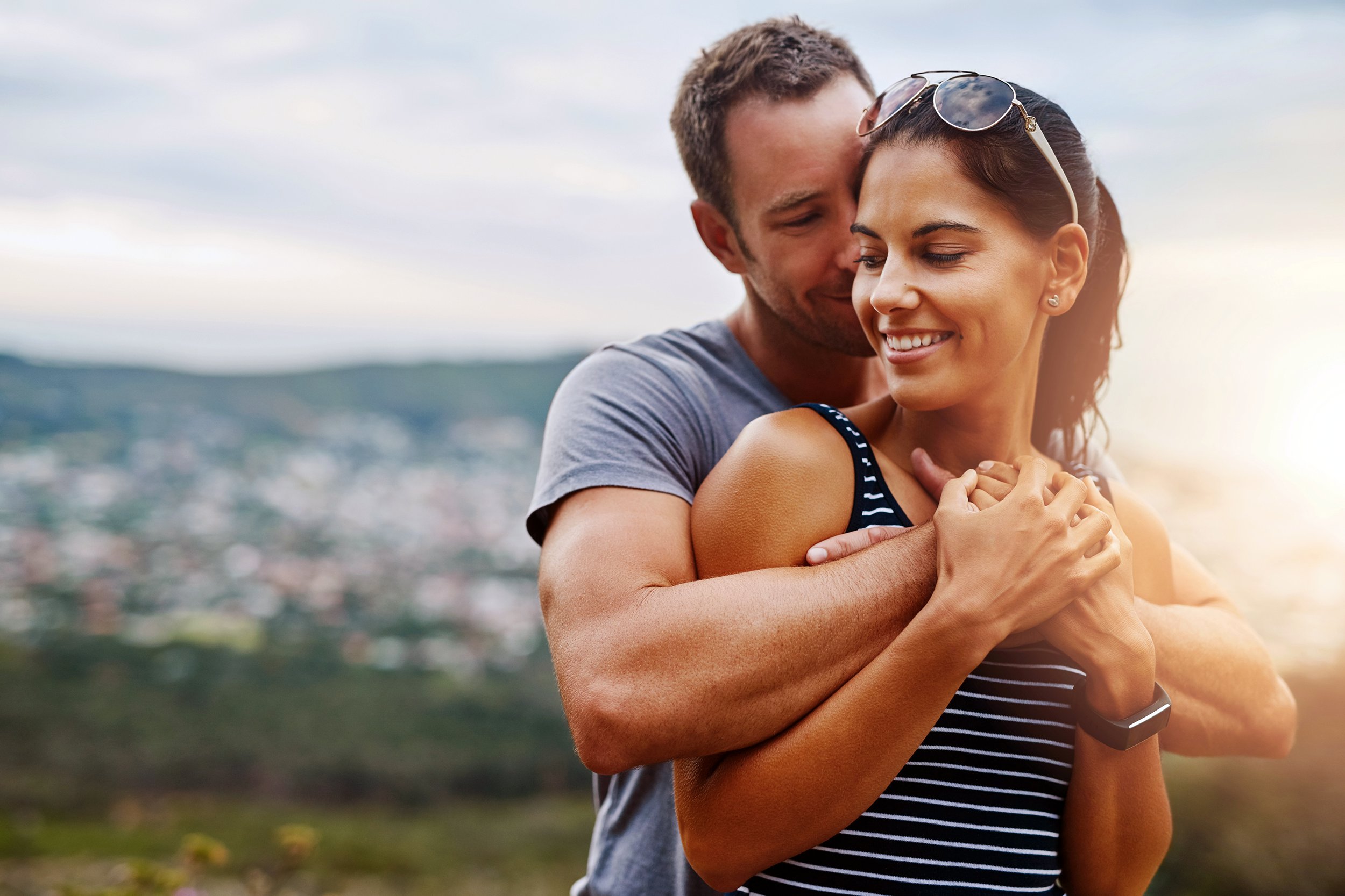 Affectionate couple hugging on a mountain