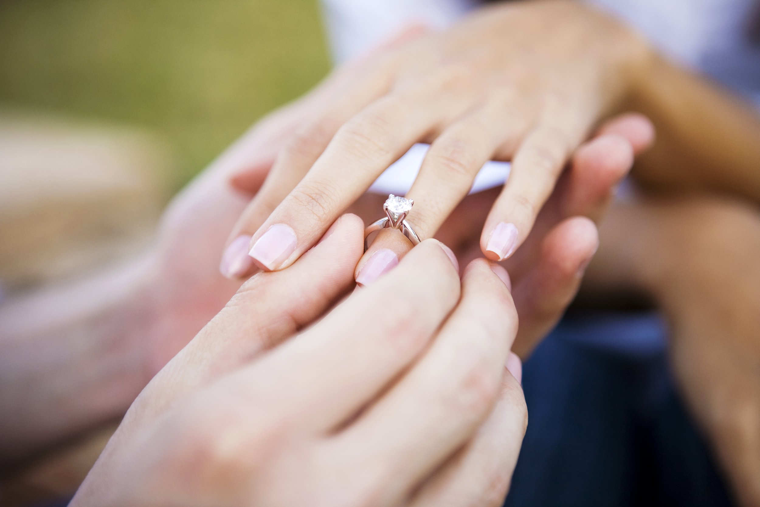 Woman's hand with a wedding or engagement ring on her finger