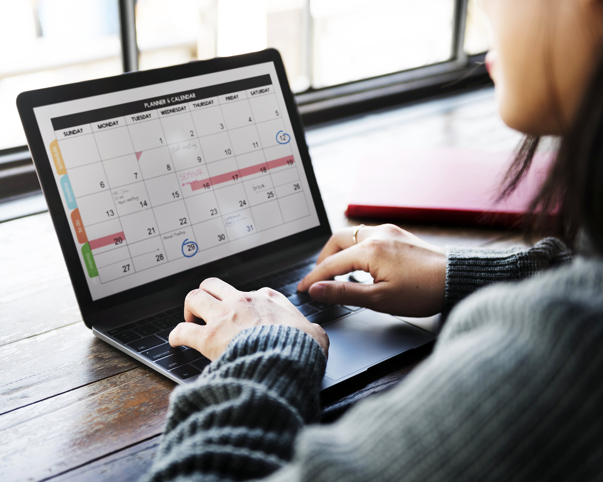 Woman planning her schedule on a laptop