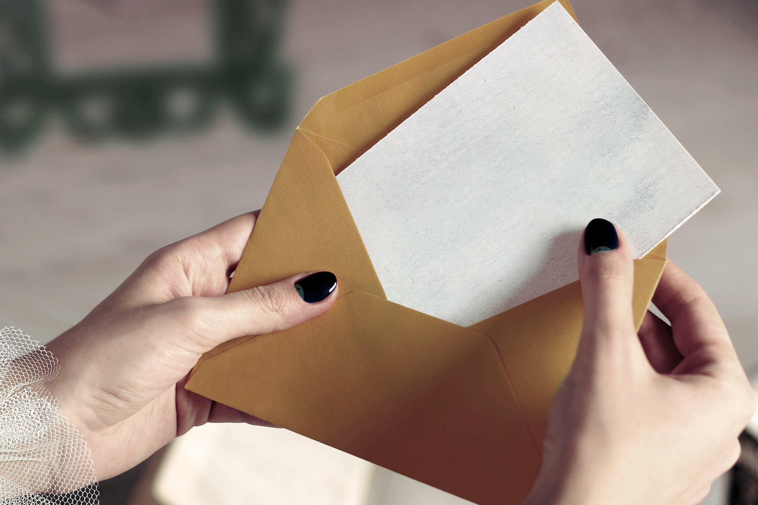 Woman's hands opening a letter