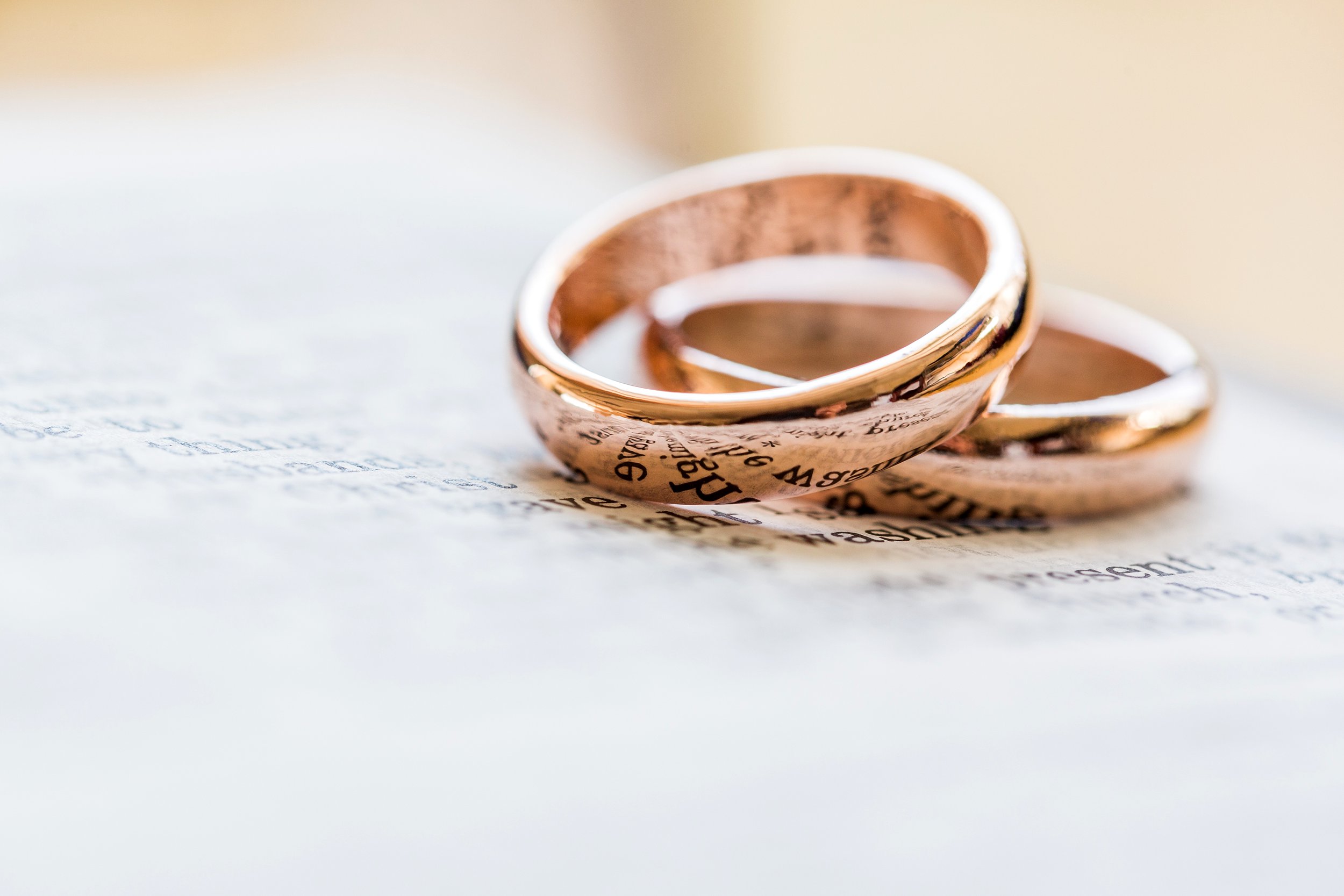 Wedding rings sitting on paper with writing