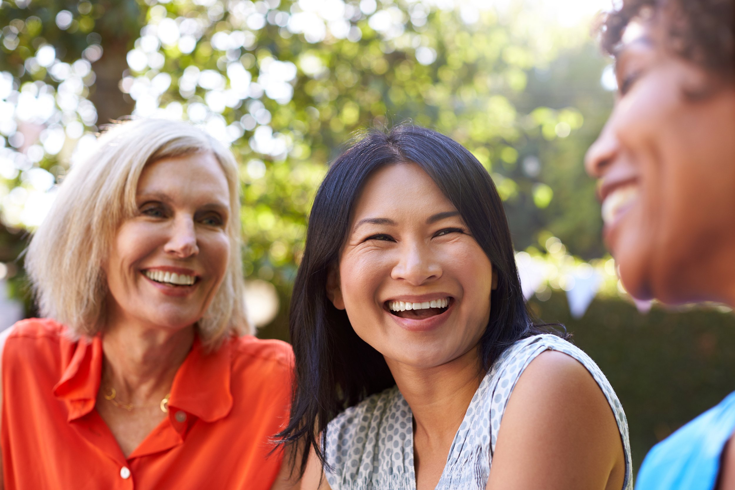 Three older women laughing and having fun