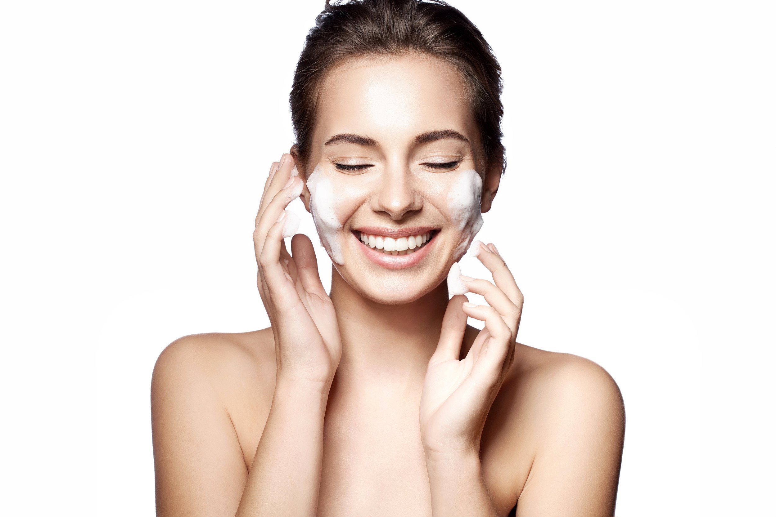 Young woman cleansing her skin