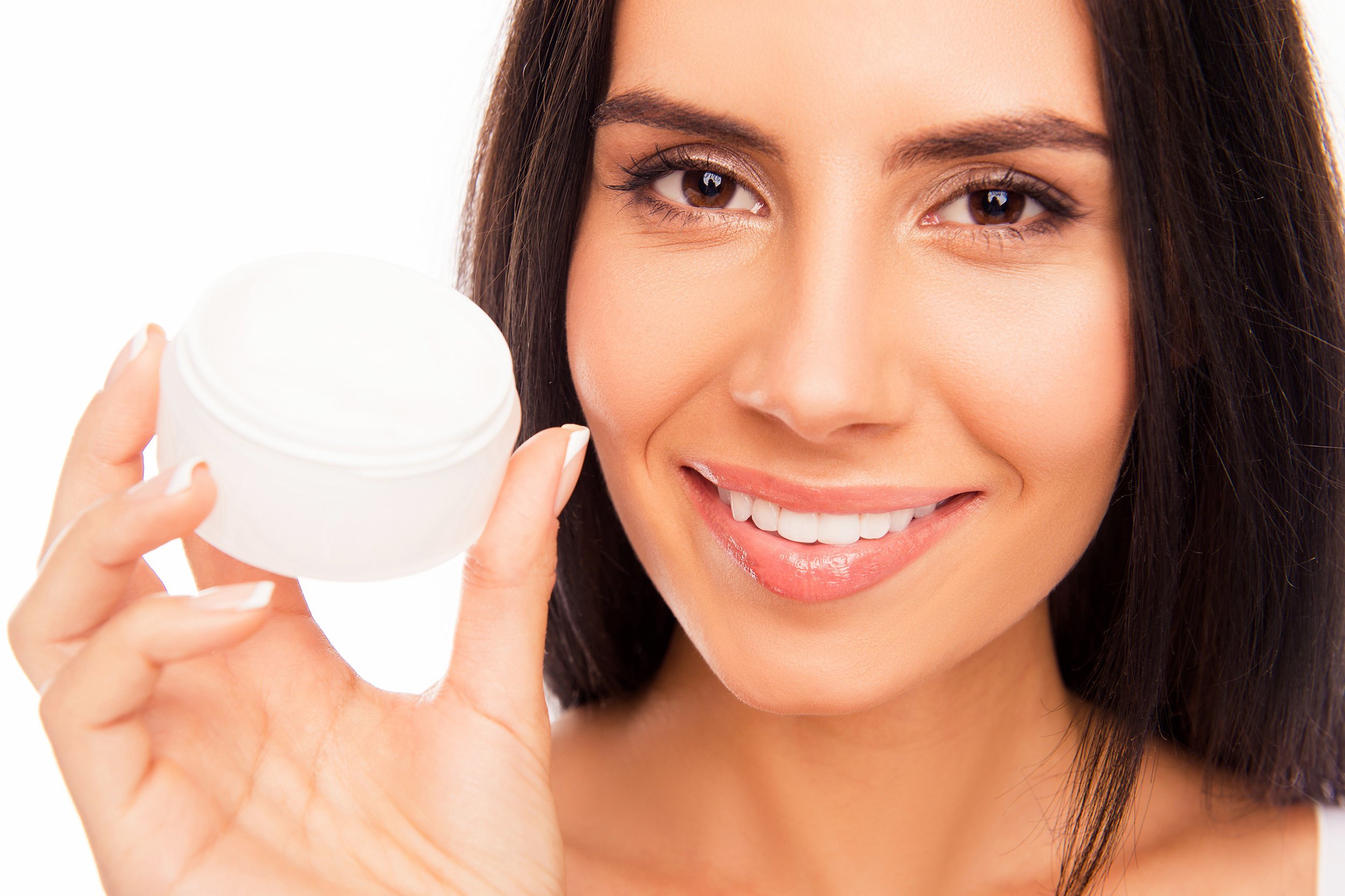 woman holding jar of cream