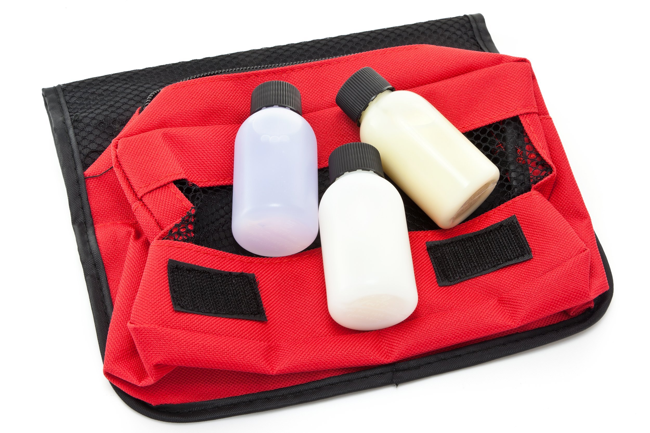 three travel sized toiletry items on a red toiletries bag