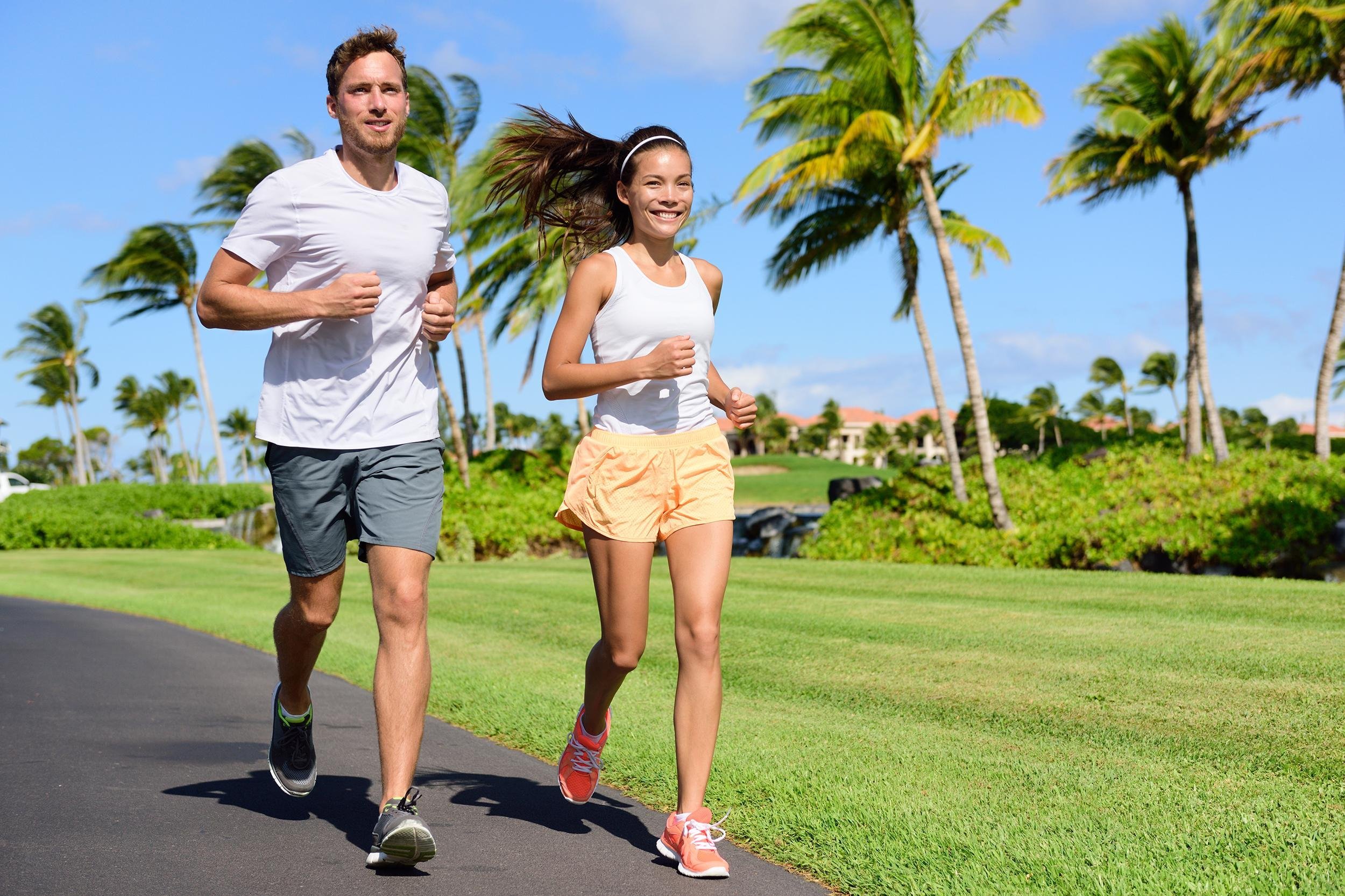 sport couple exercising running outside on street in summer