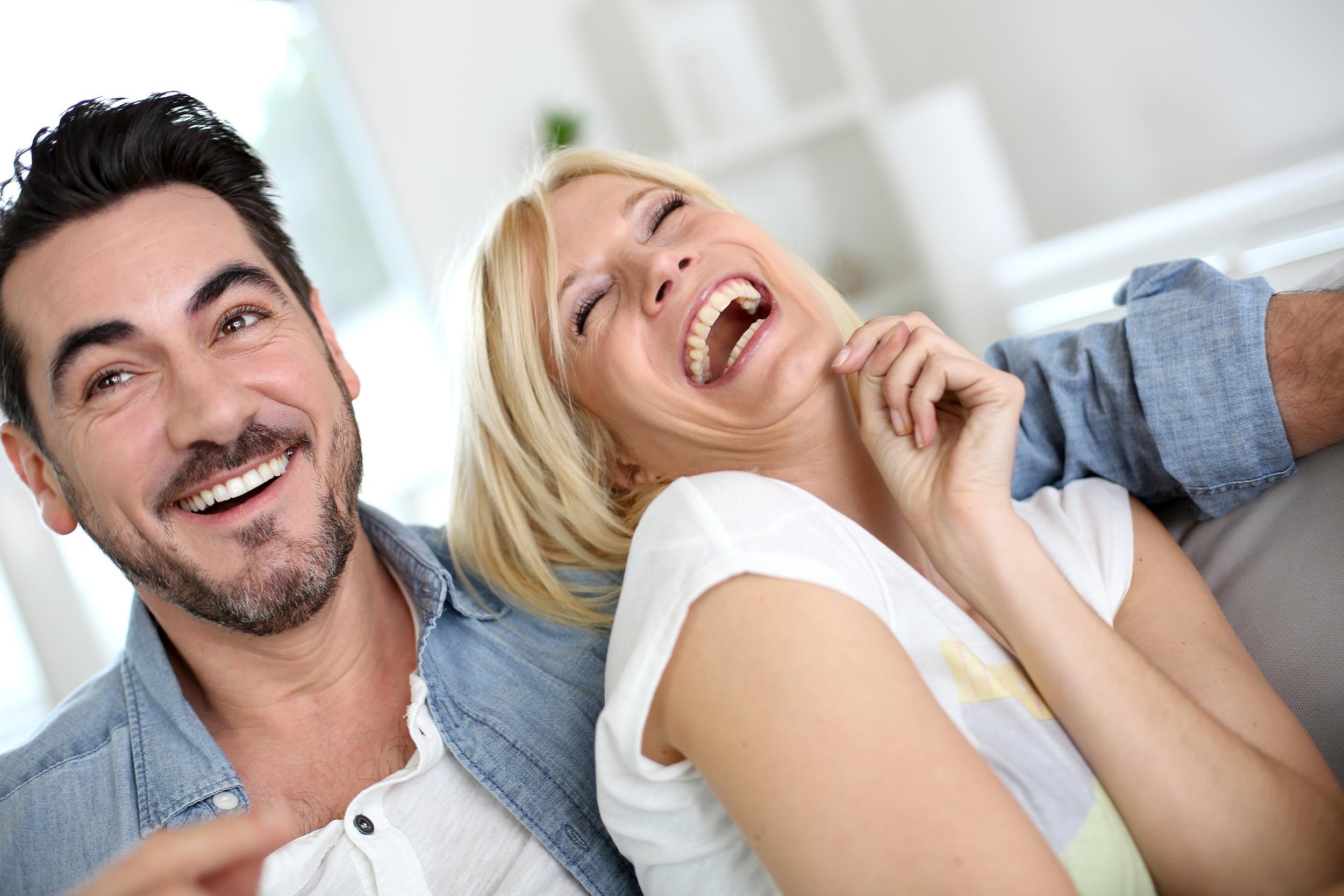 in love couple laughing on the couch