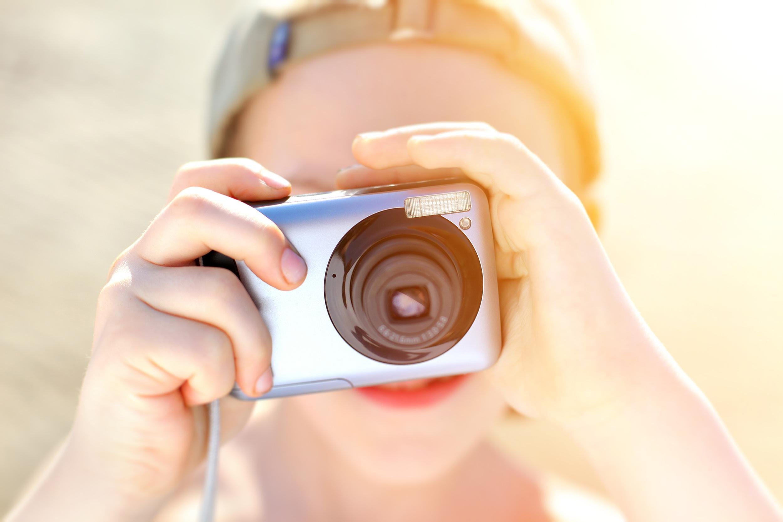 child taking picture with camera
