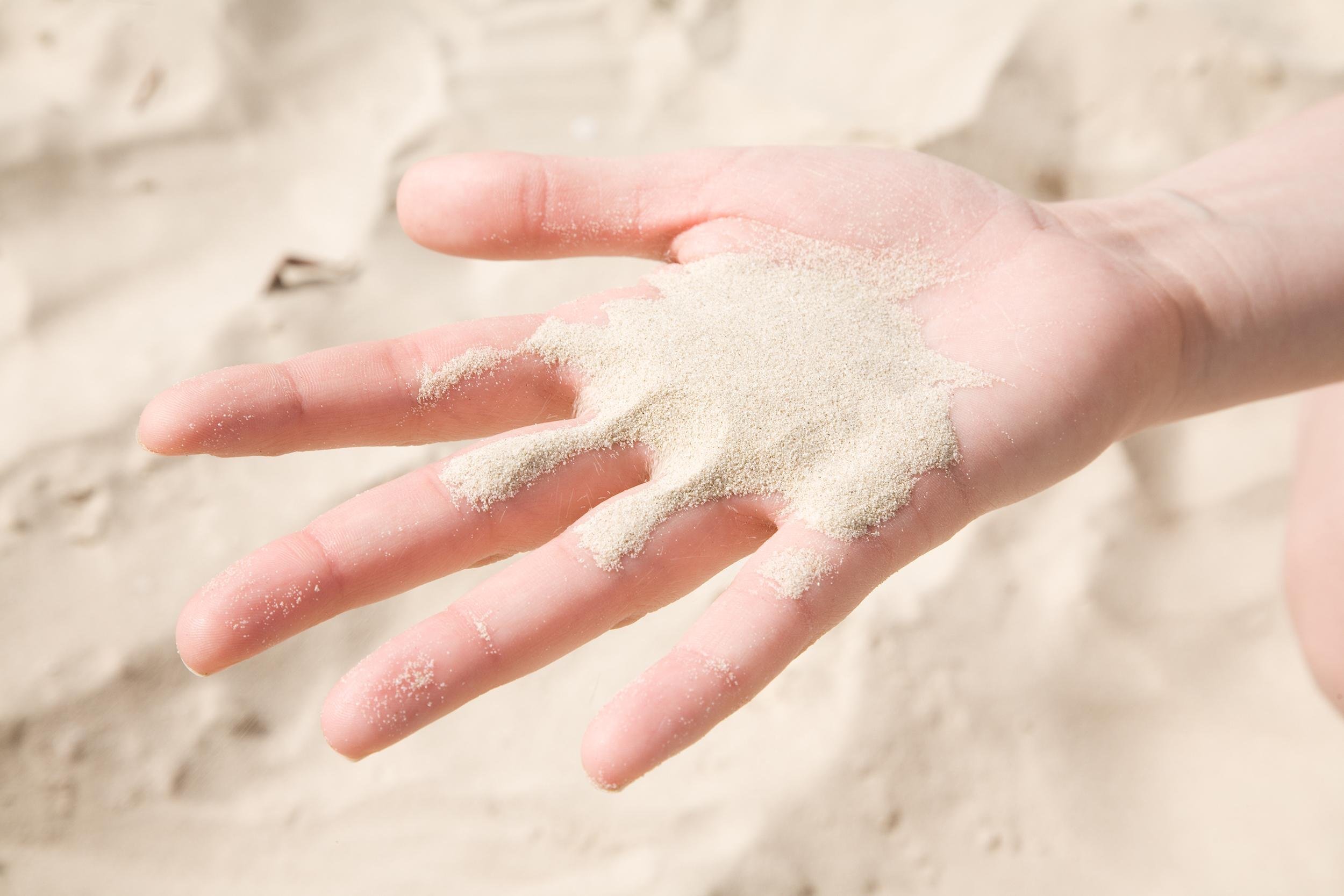 sand in hand at the beach