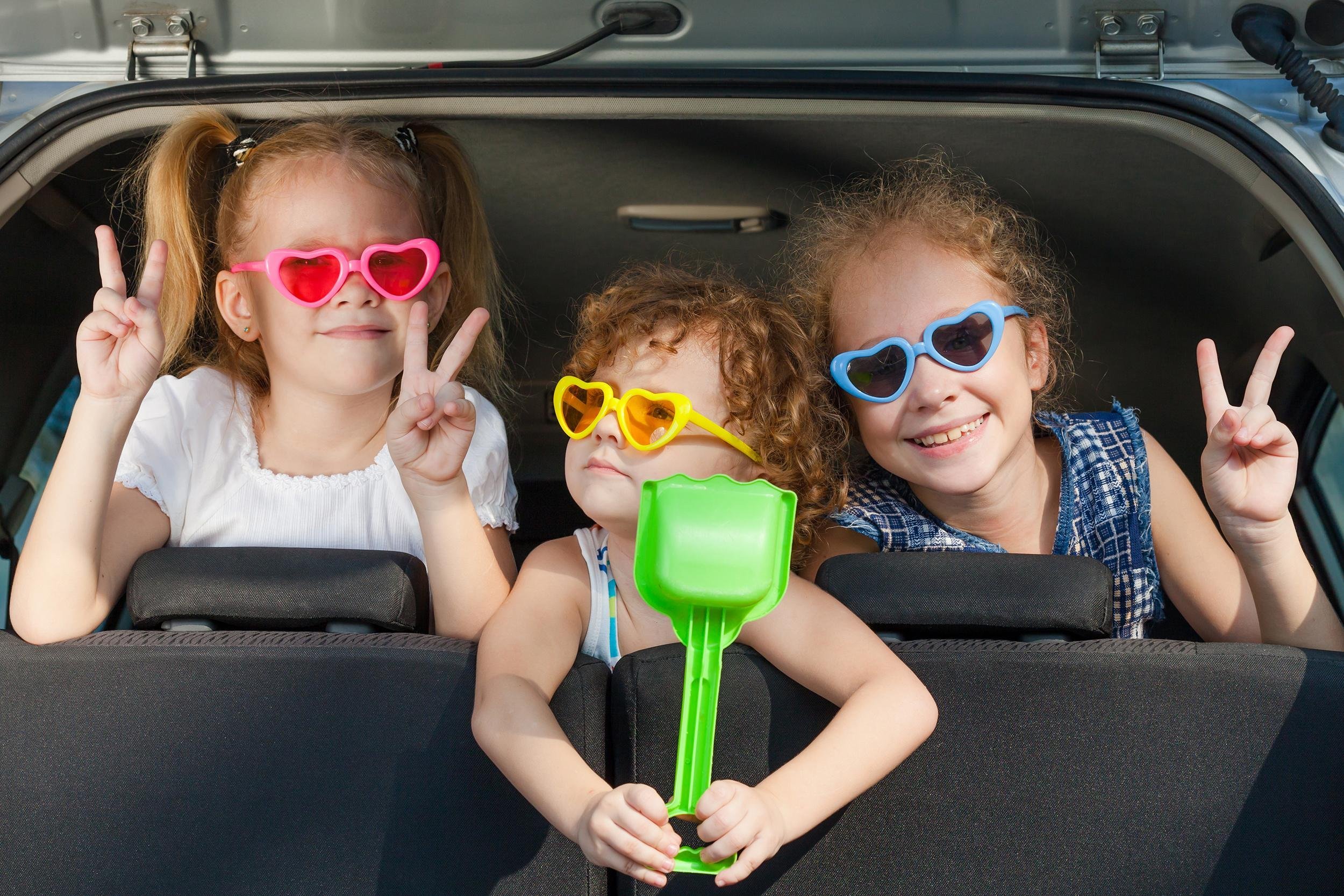 kids hanging out in trunk of car