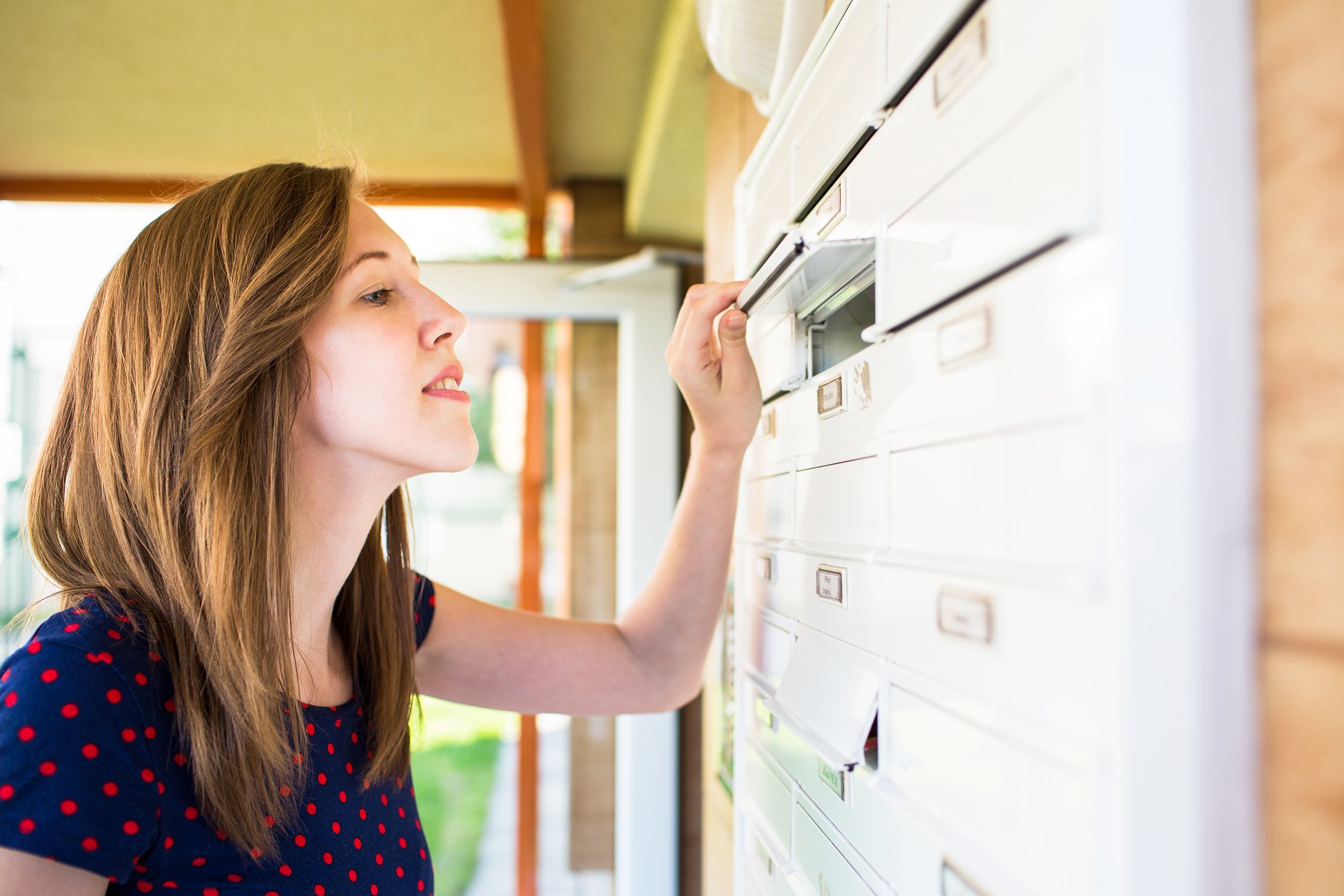 woman checking her mailbox for new letters