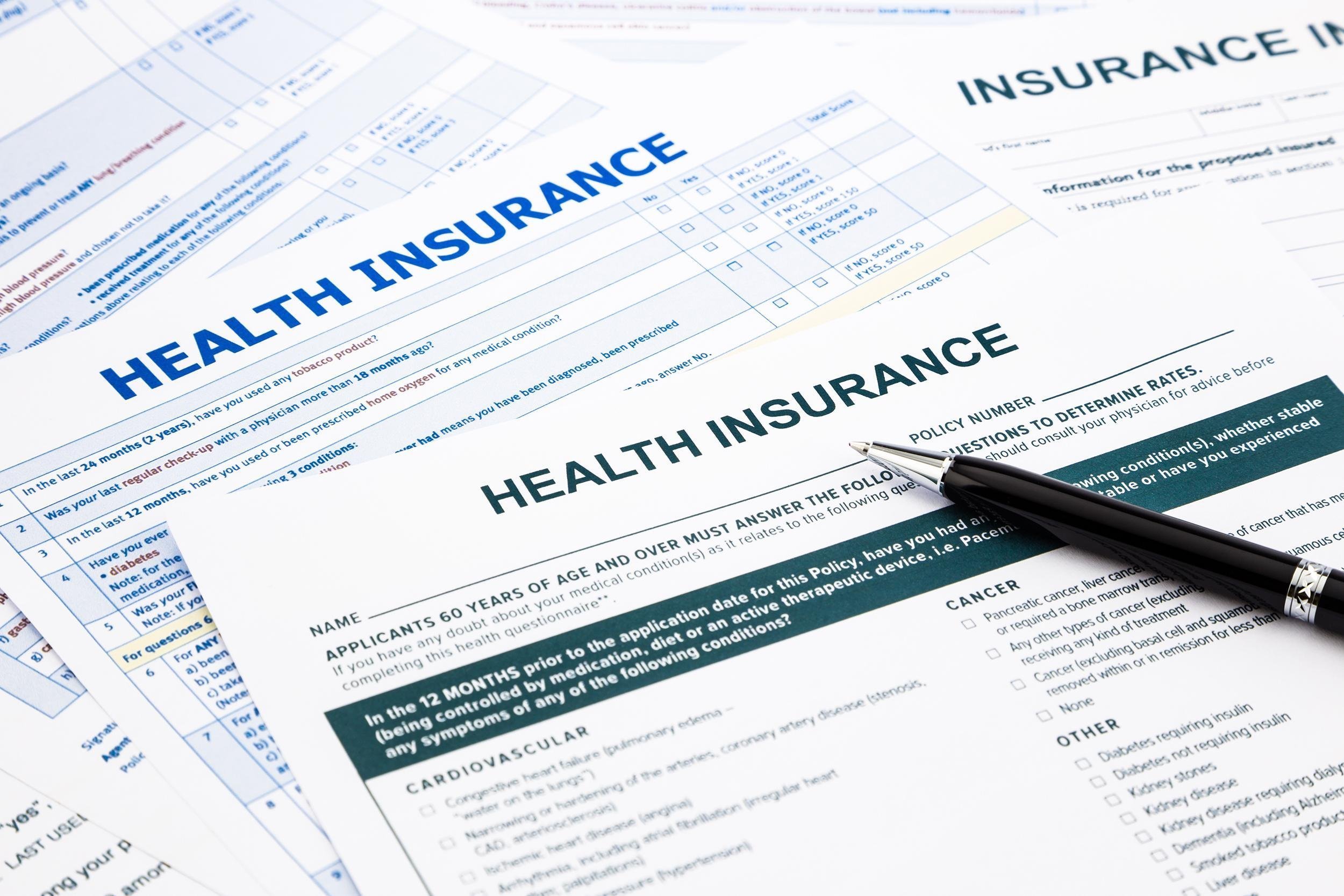 health insurance forms with pen