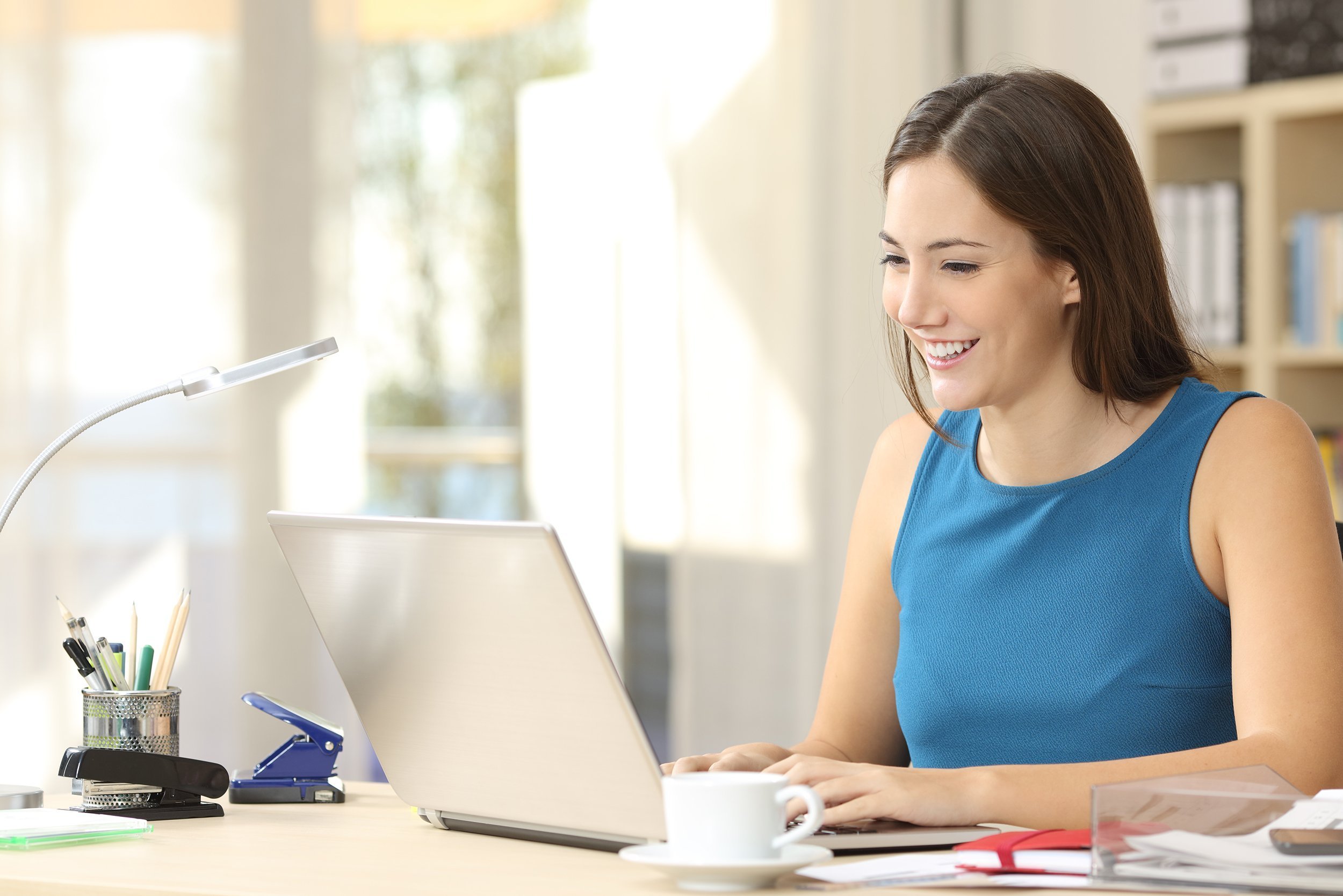 happy entrepreneur working on line typing with a laptop in home office