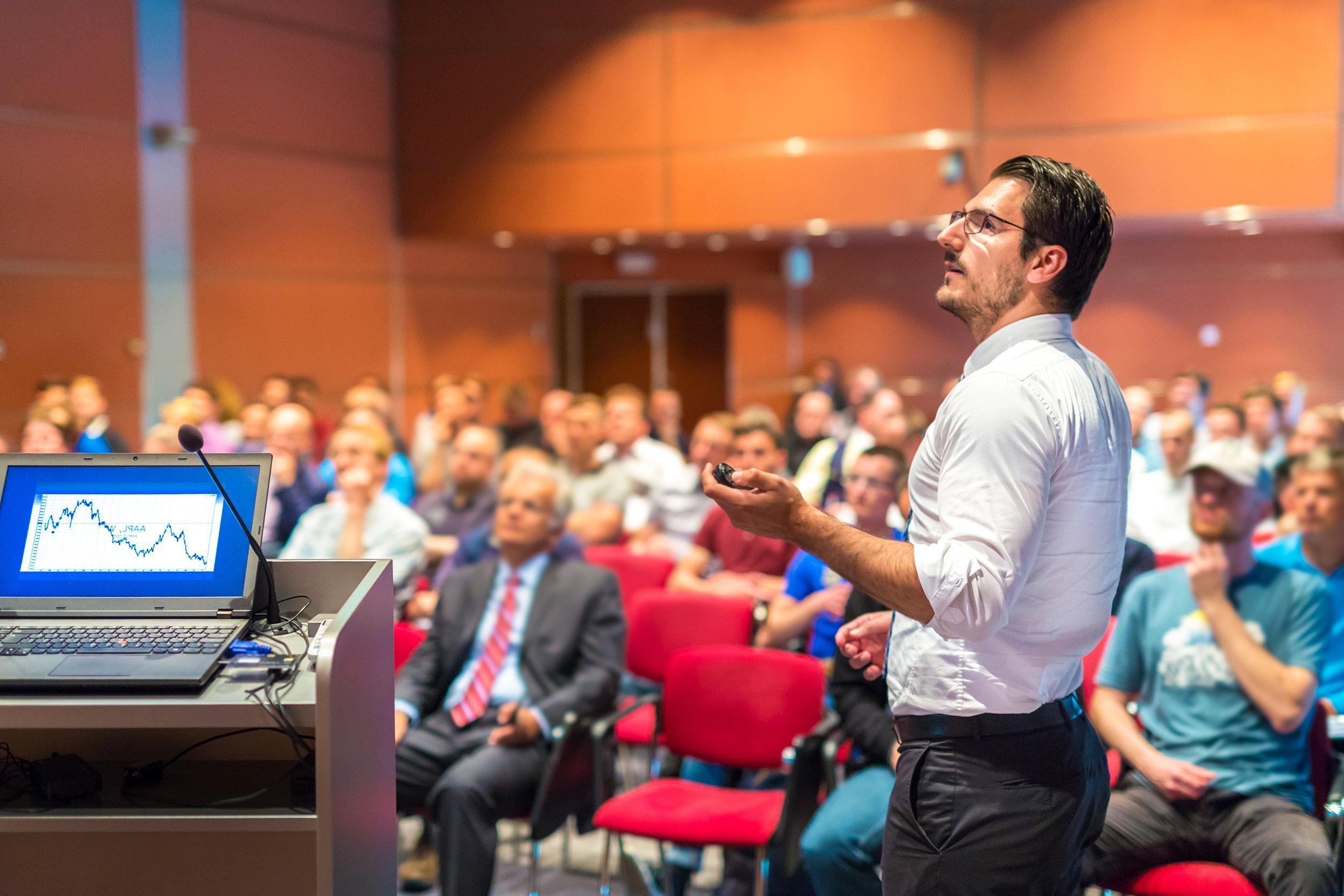 speaker giving a talk at a corporate business conference