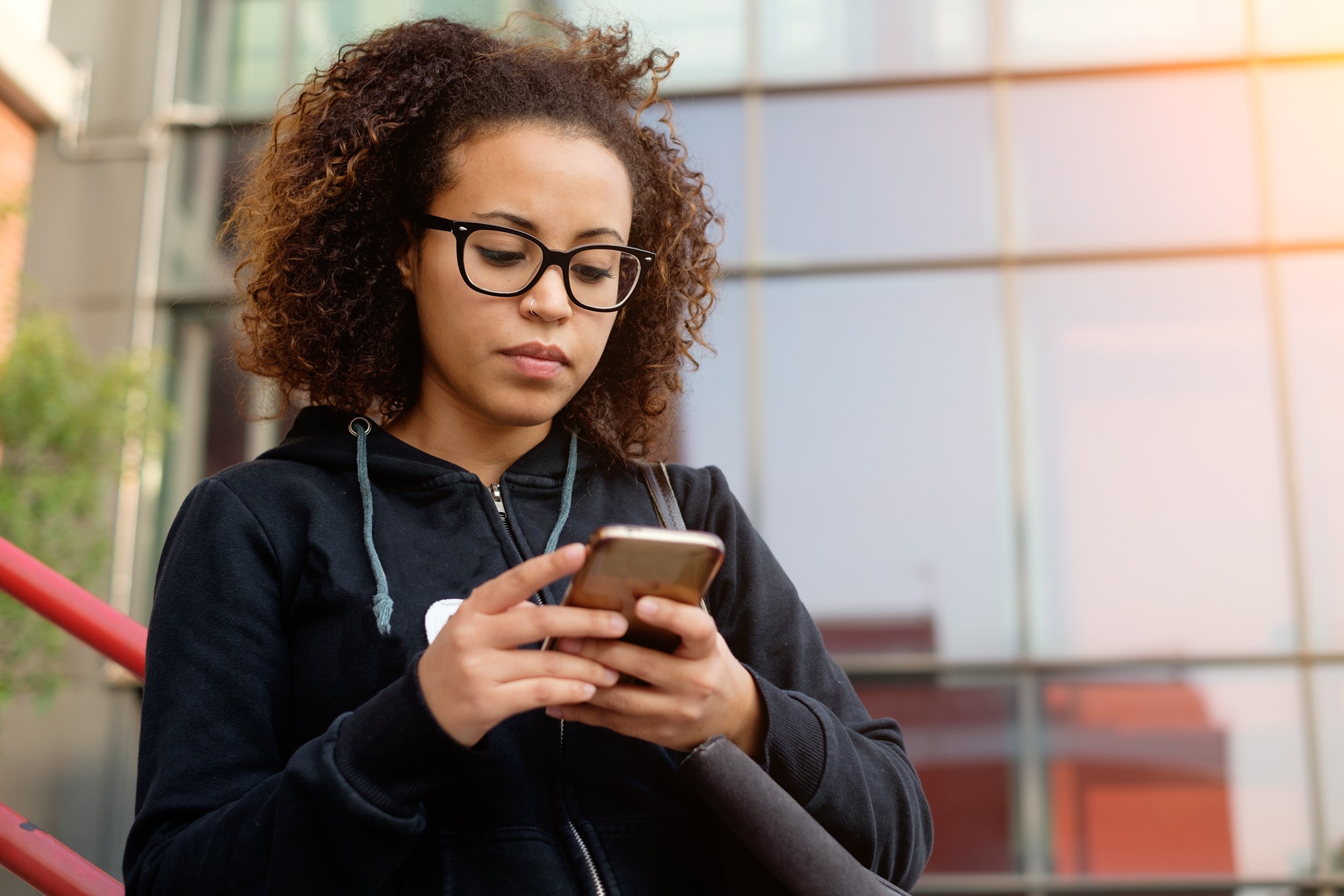 young African American woman texting on her phone
