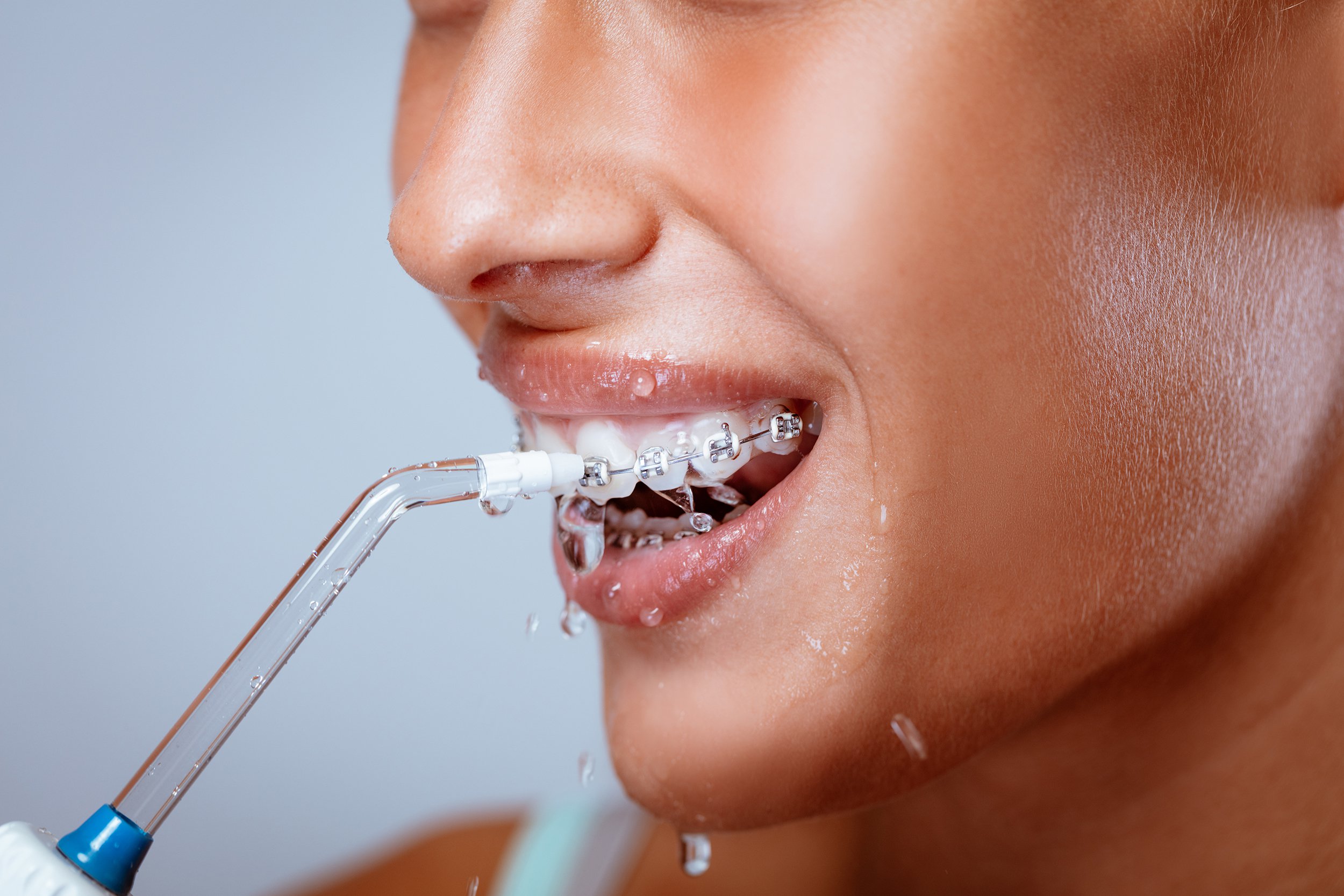 woman using water flosser