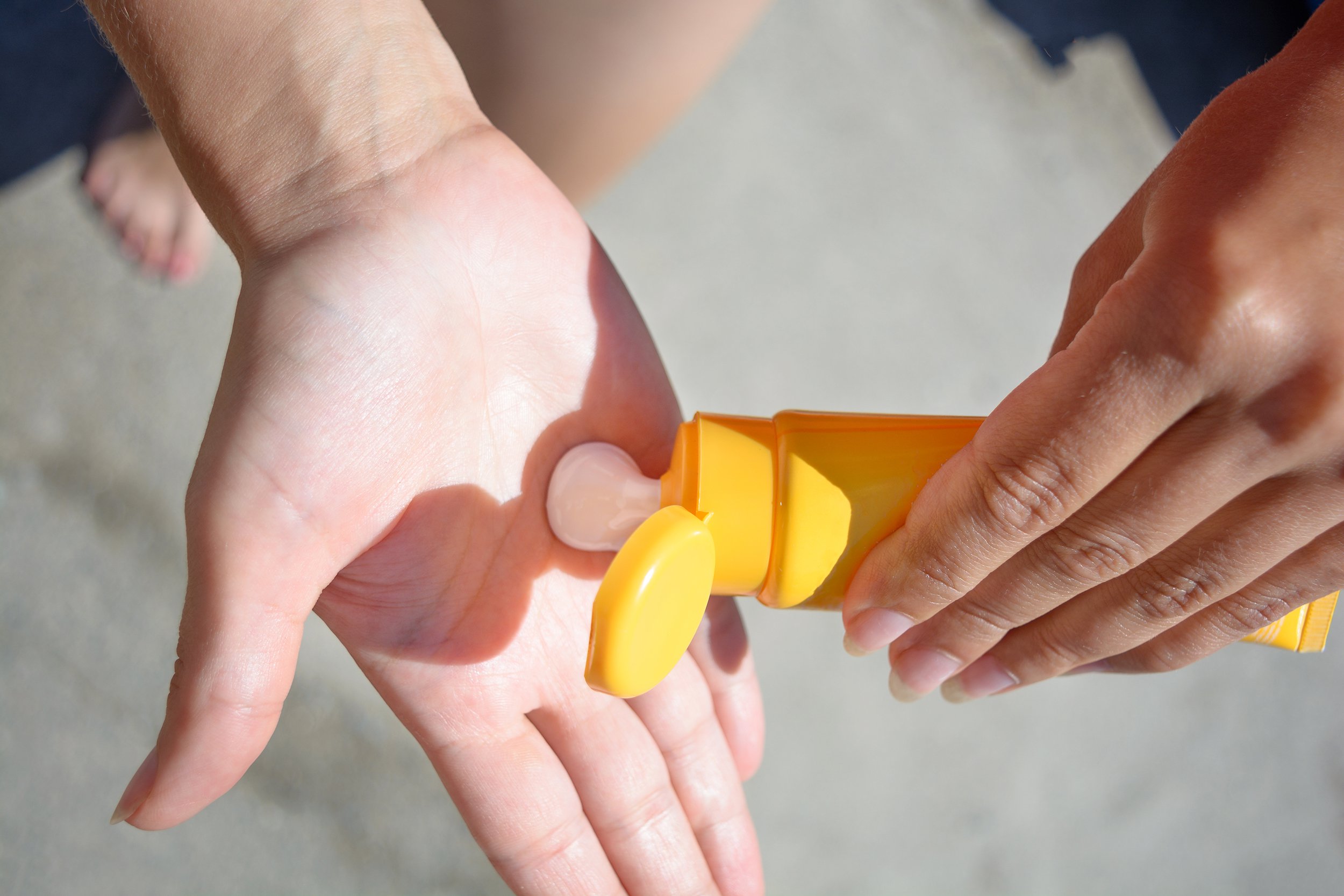 female hands with sun protection cream