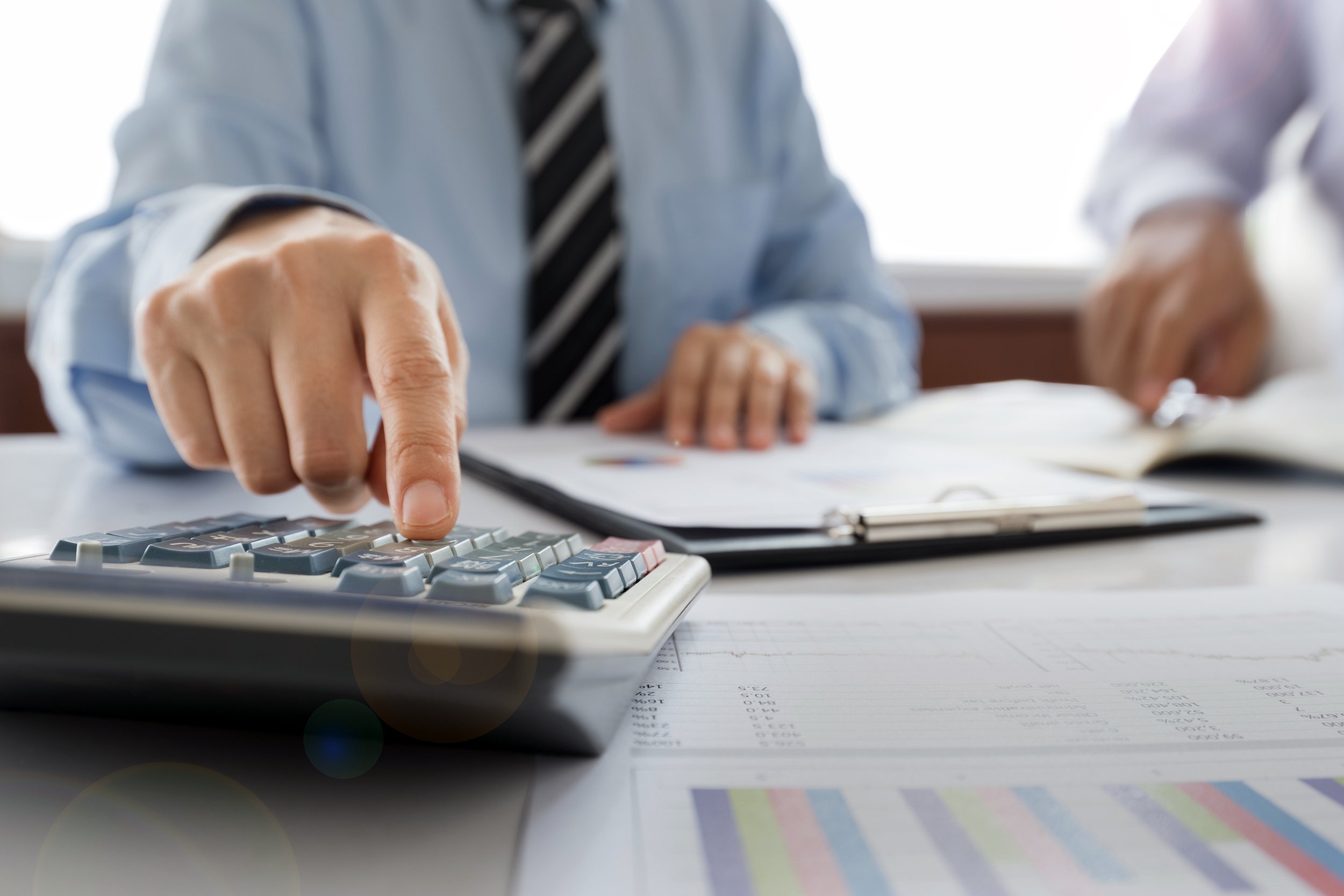 Tax accountant working with calculator