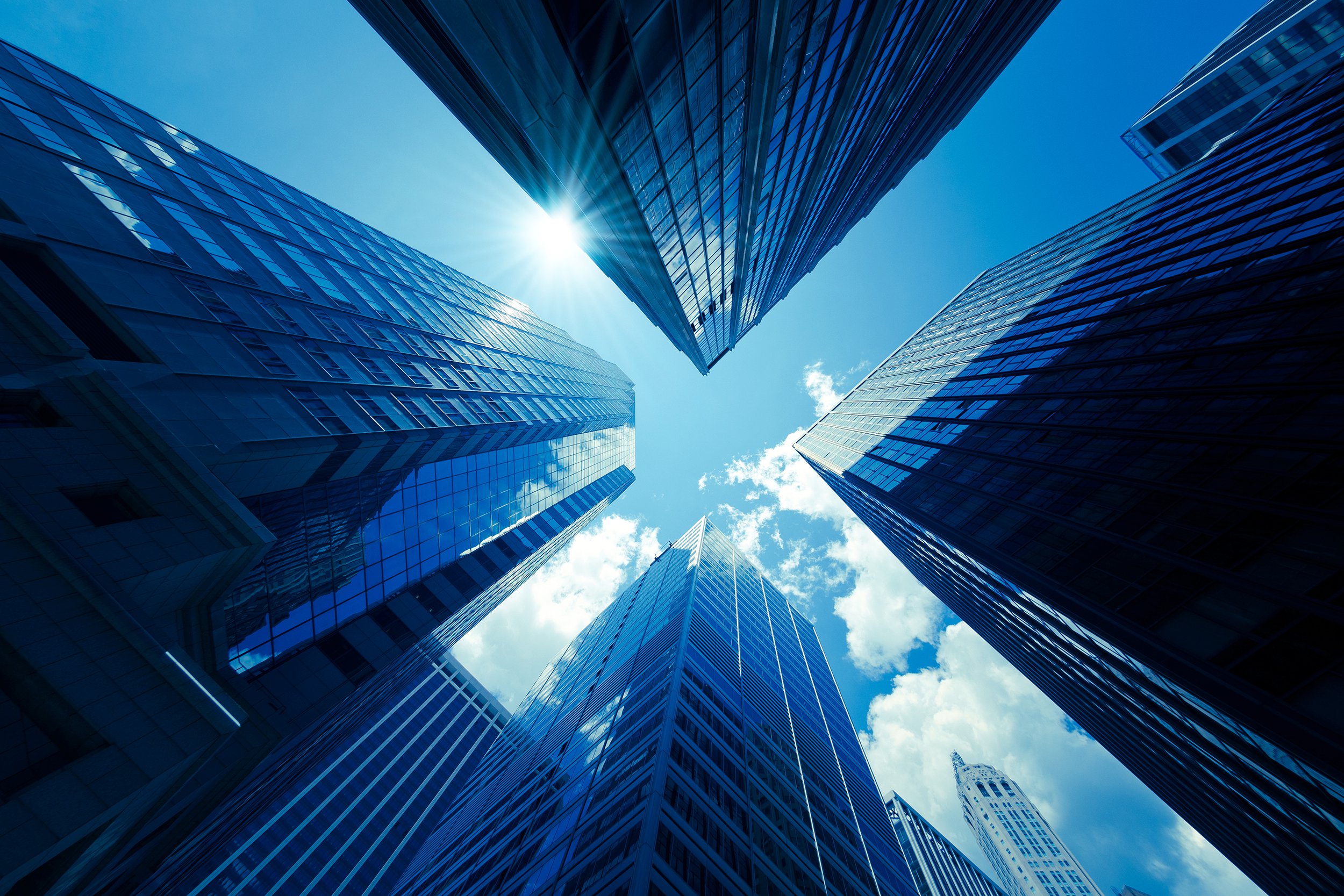 View looking up at tall downtown urban buildings