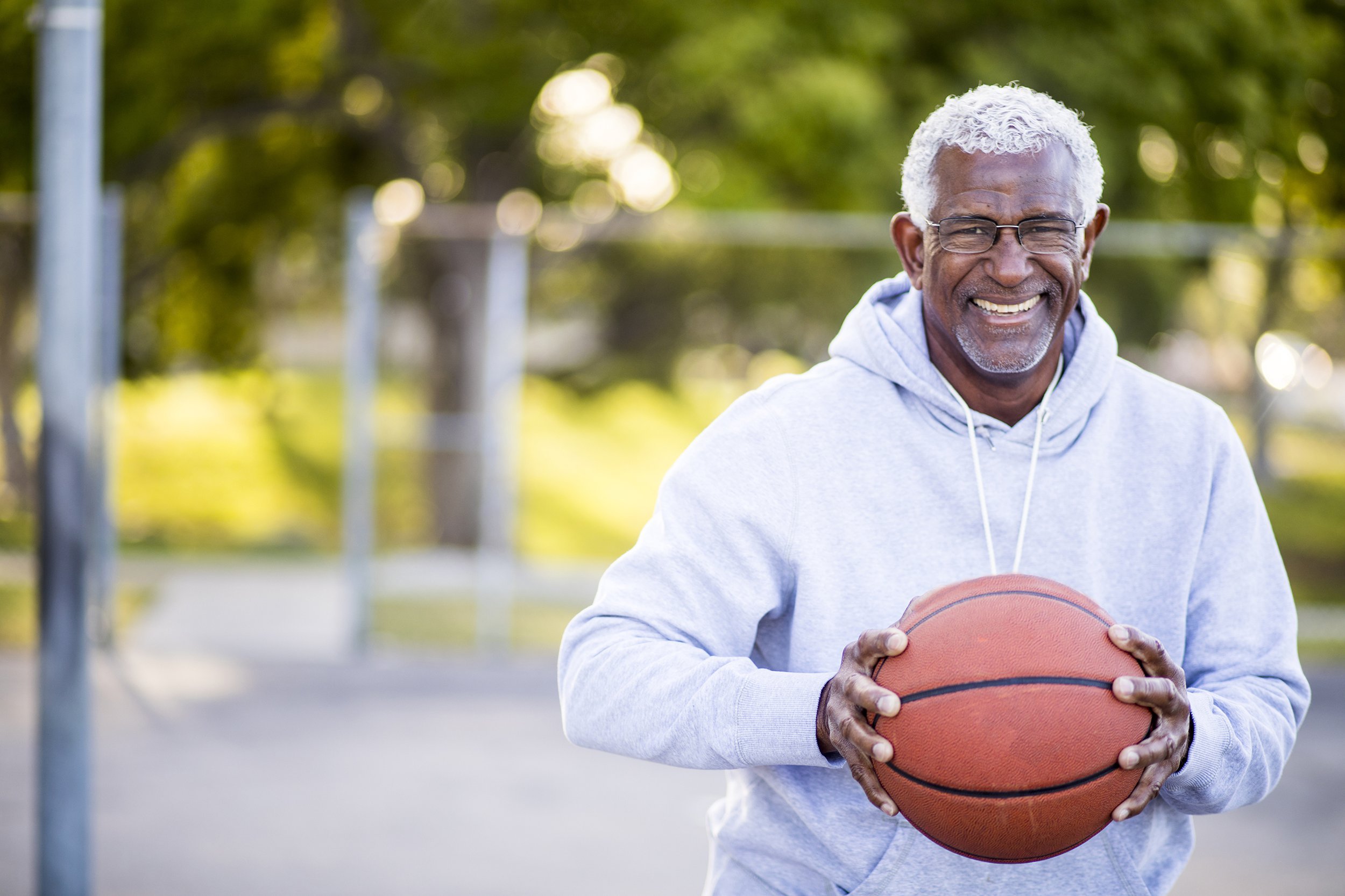 Senior man playing basketball